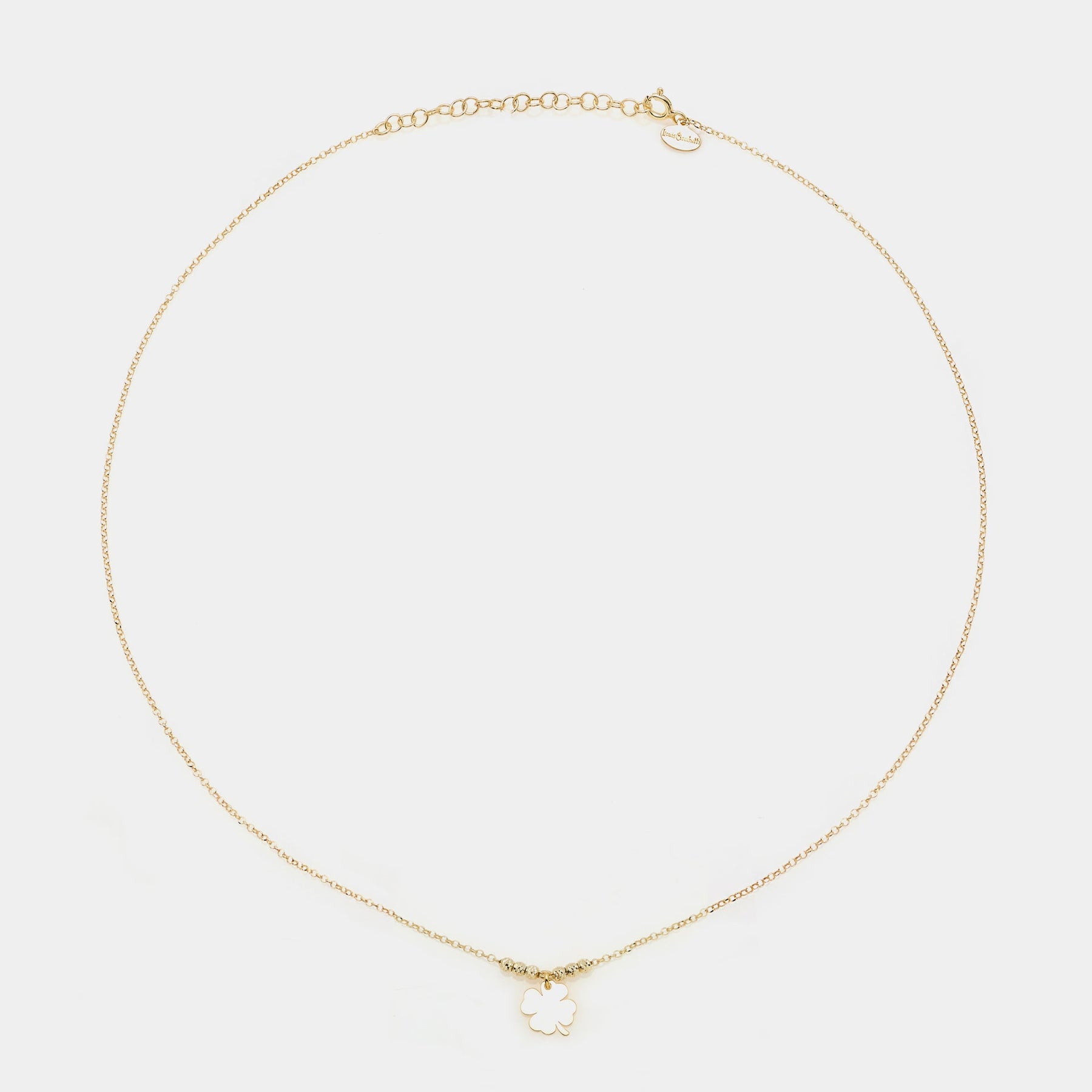 Gold-plated silver necklace with a central hanging four-leaf clover and 3 faceted spheres on the sides