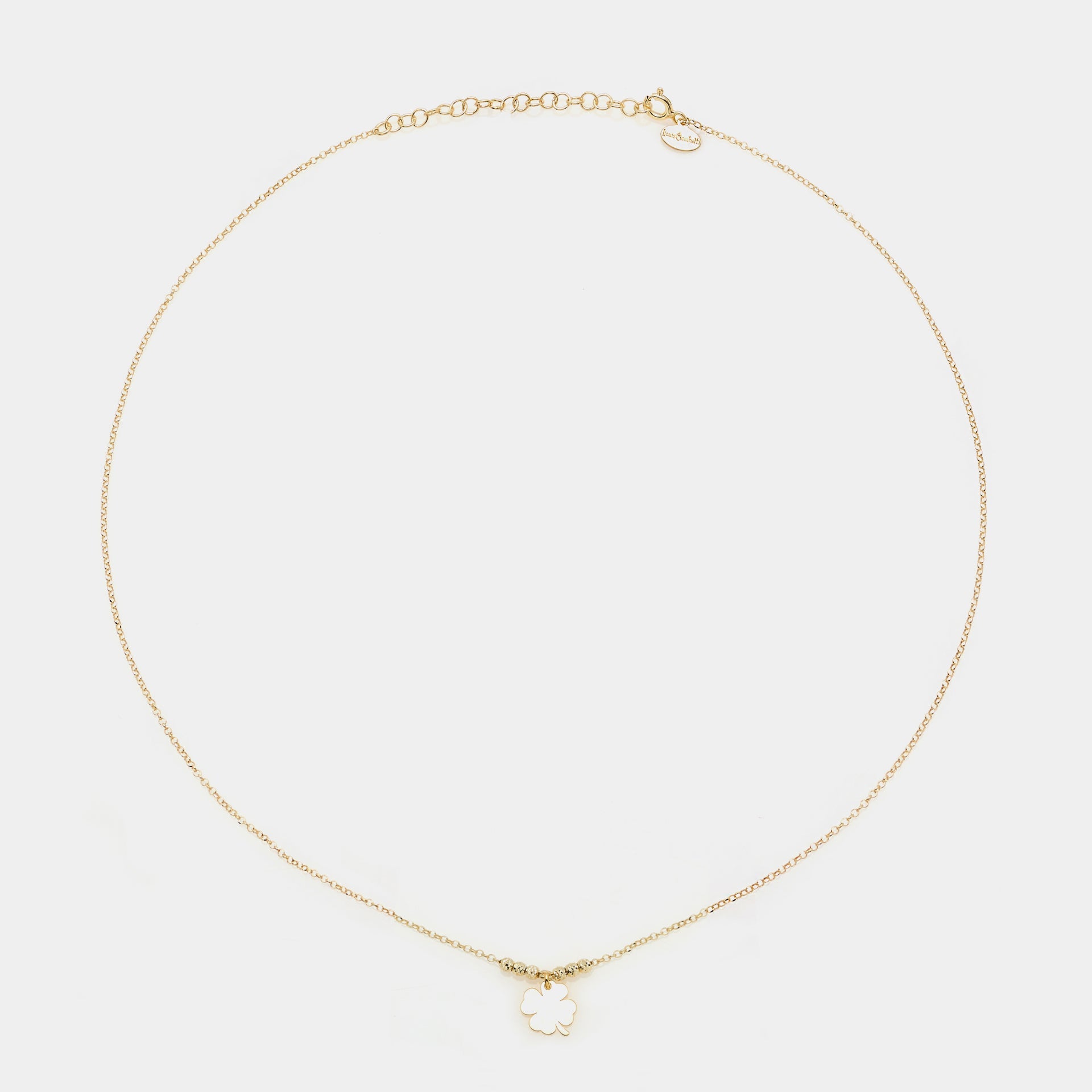 Gold-plated silver necklace with a central hanging four-leaf clover and 3 faceted spheres on the sides