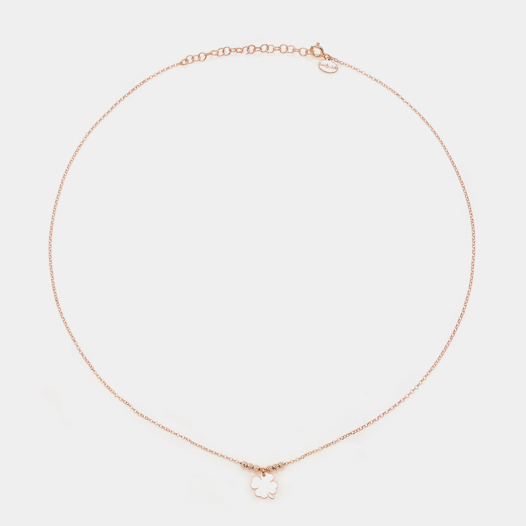 Rose gold silver necklace with a central hanging four-leaf clover and 3 faceted spheres on the sides