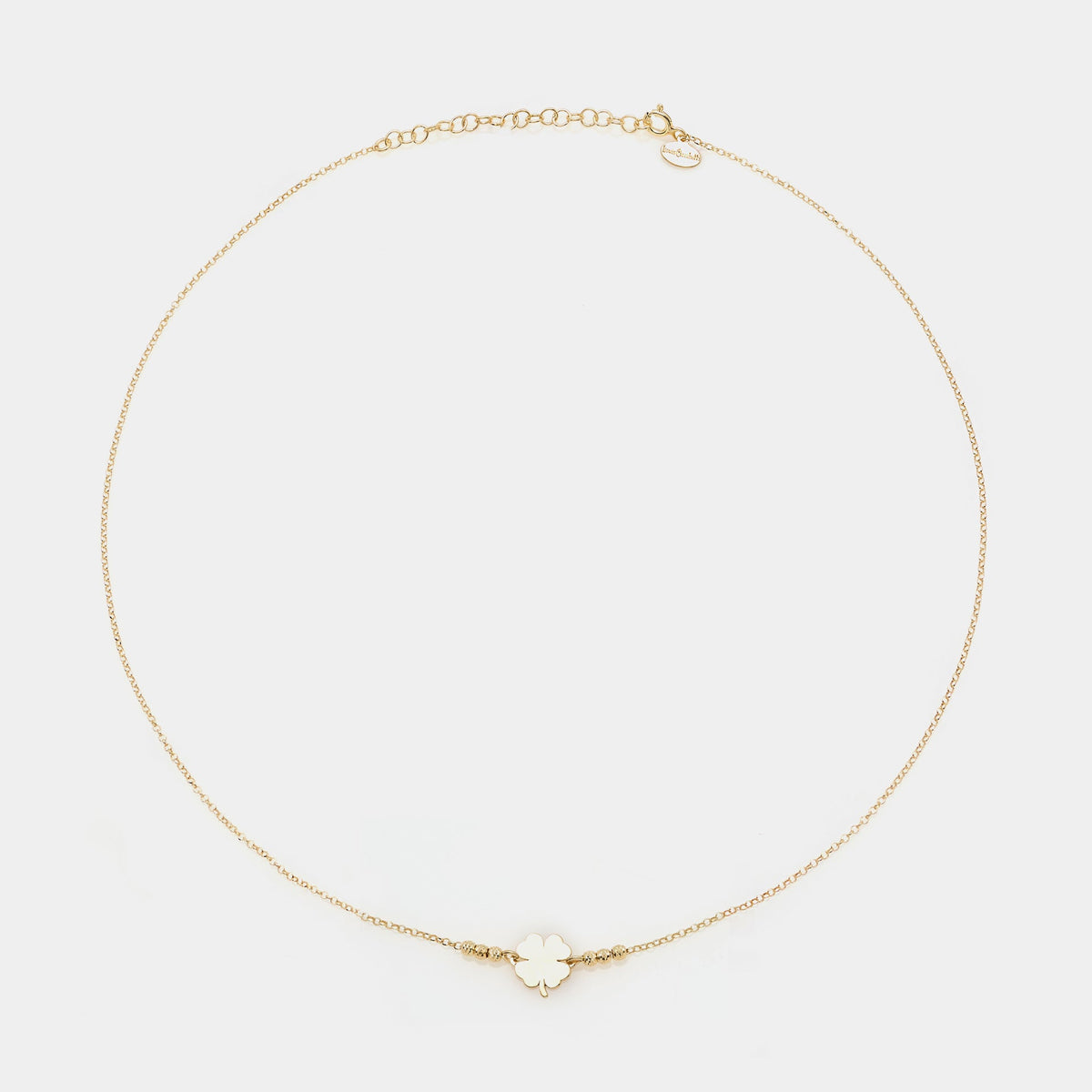 Gold-plated silver necklace with clover centerpiece and 3 faceted spheres on the sides