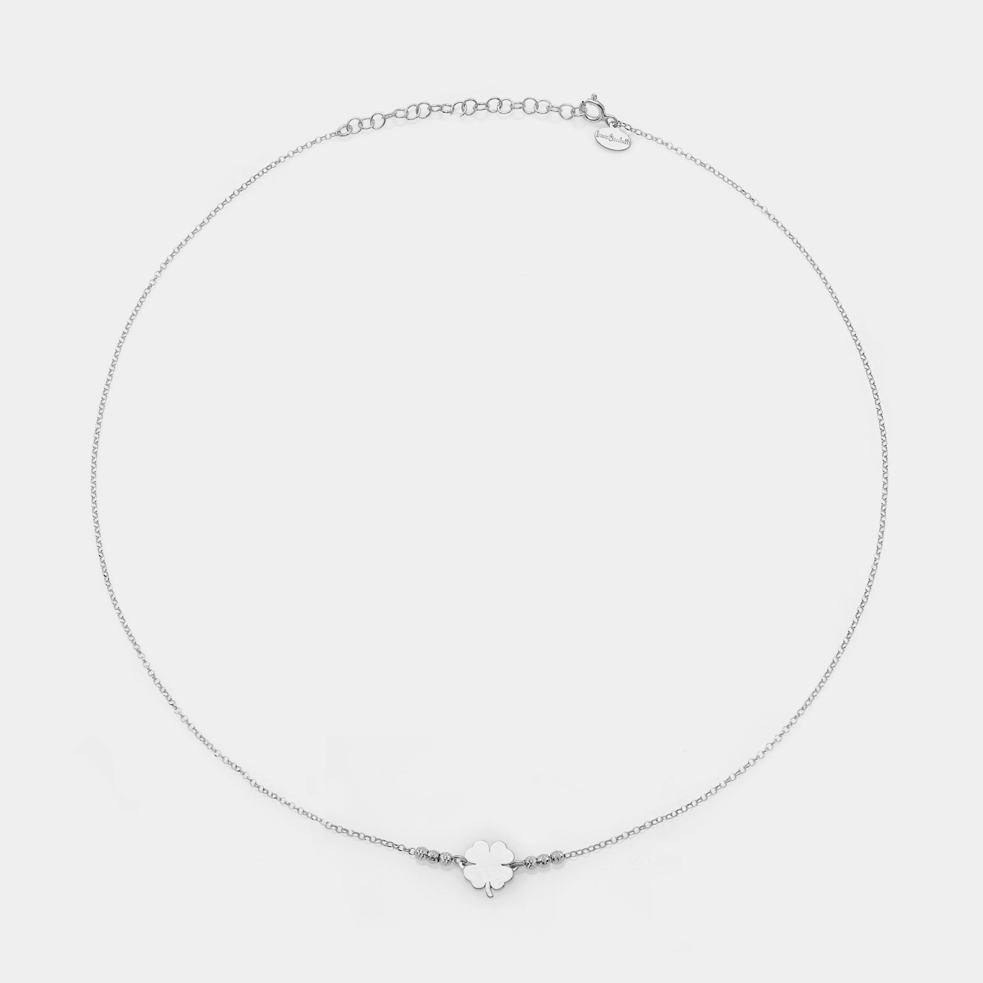 Rhodium-plated silver necklace with clover centerpiece and 3 faceted spheres on the sides