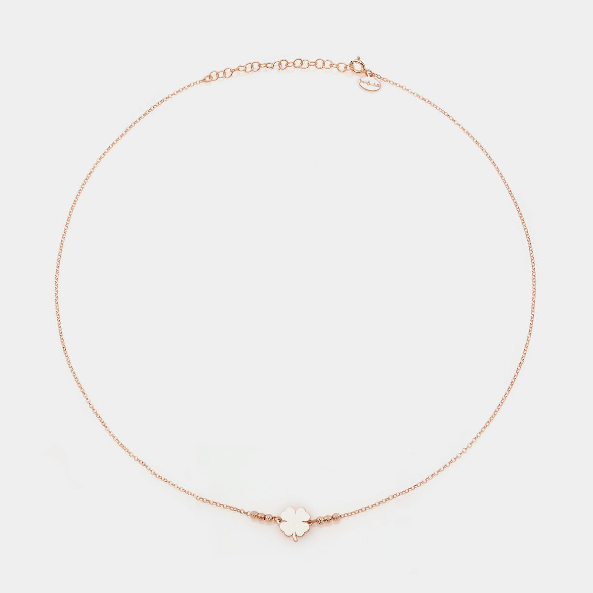 Rose gold silver necklace with clover centerpiece and 3 faceted spheres on the sides
