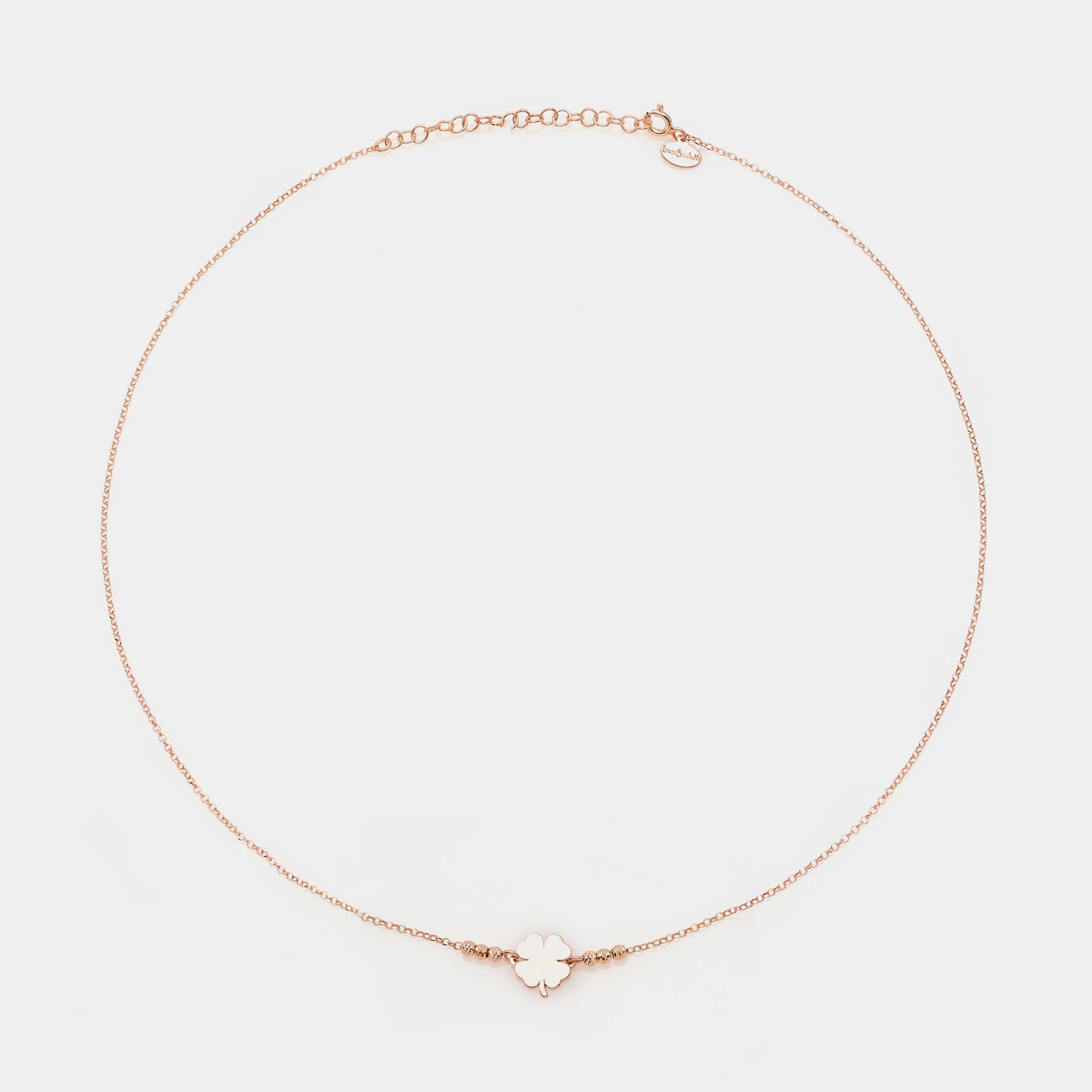 Rose gold silver necklace with clover centerpiece and 3 faceted spheres on the sides