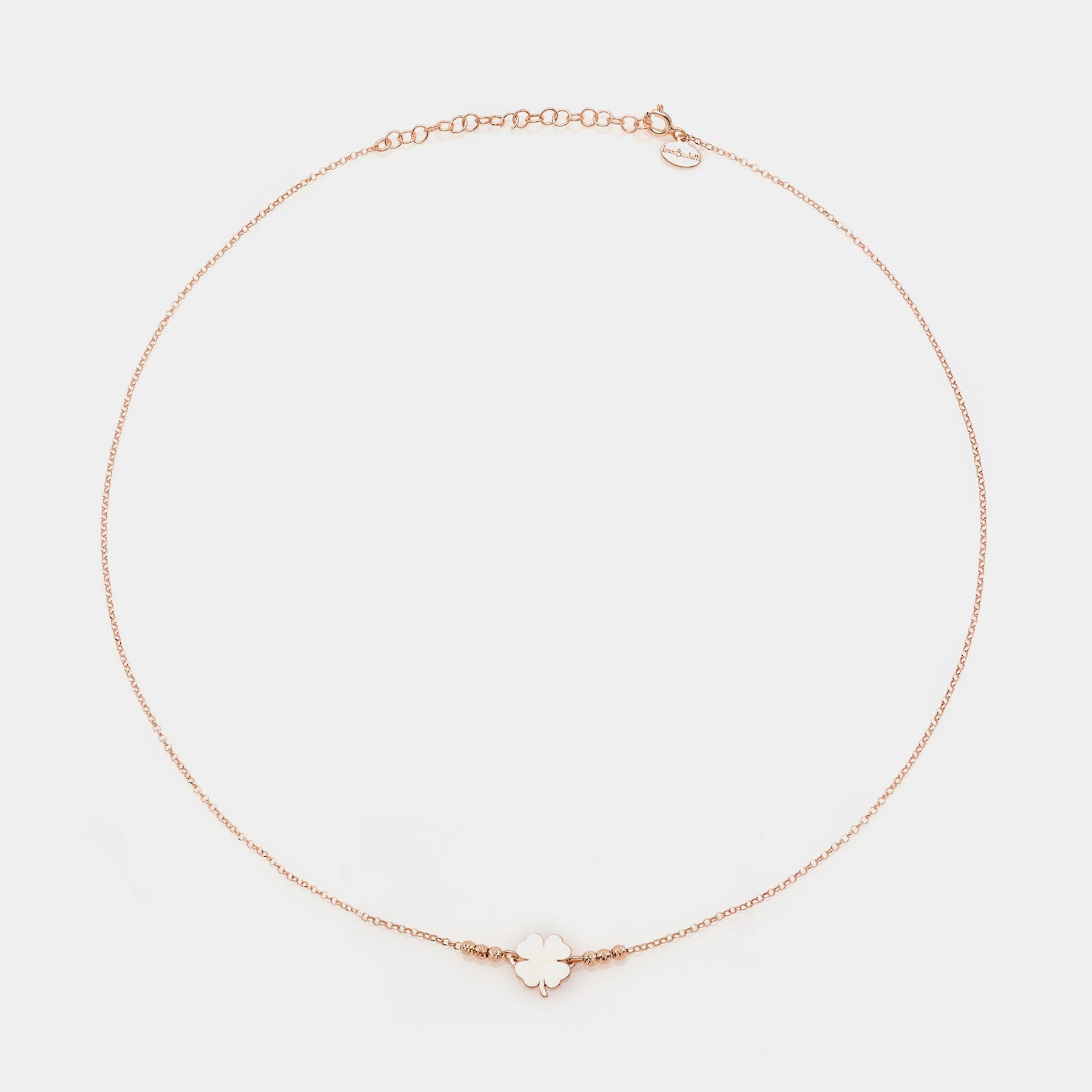 Rose gold silver necklace with clover centerpiece and 3 faceted spheres on the sides