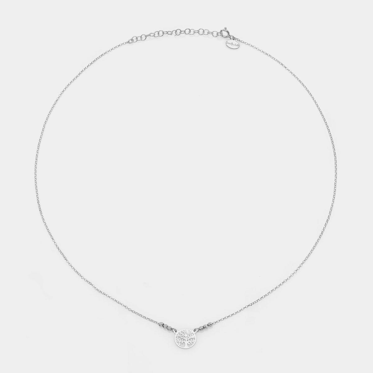 Rhodium-plated silver necklace with round pierced tree of life centerpiece and 3 faceted spheres on the sides