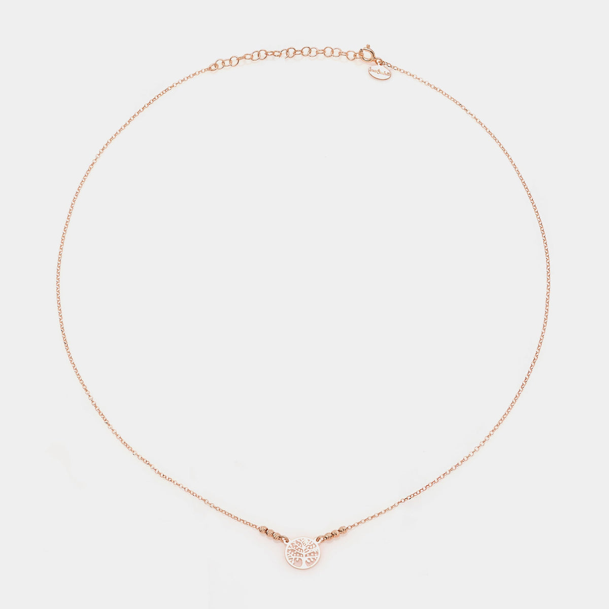 Rose gold silver necklace with round pierced tree of life centerpiece and 3 faceted spheres on the sides