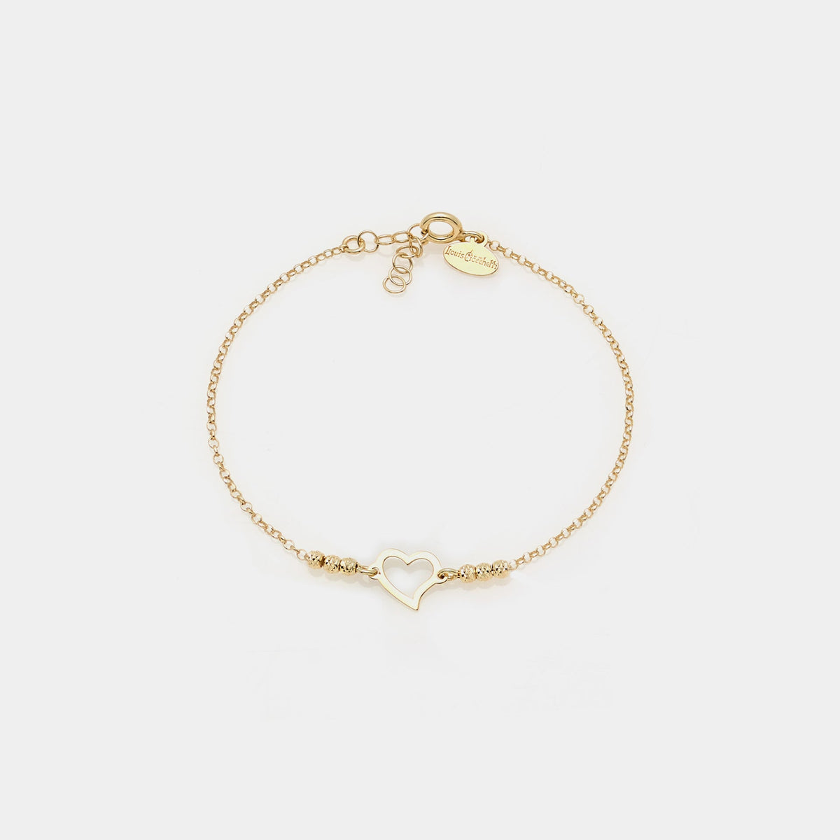 Gold-plated silver bracelet with faceted spheres and central twisted pierced heart