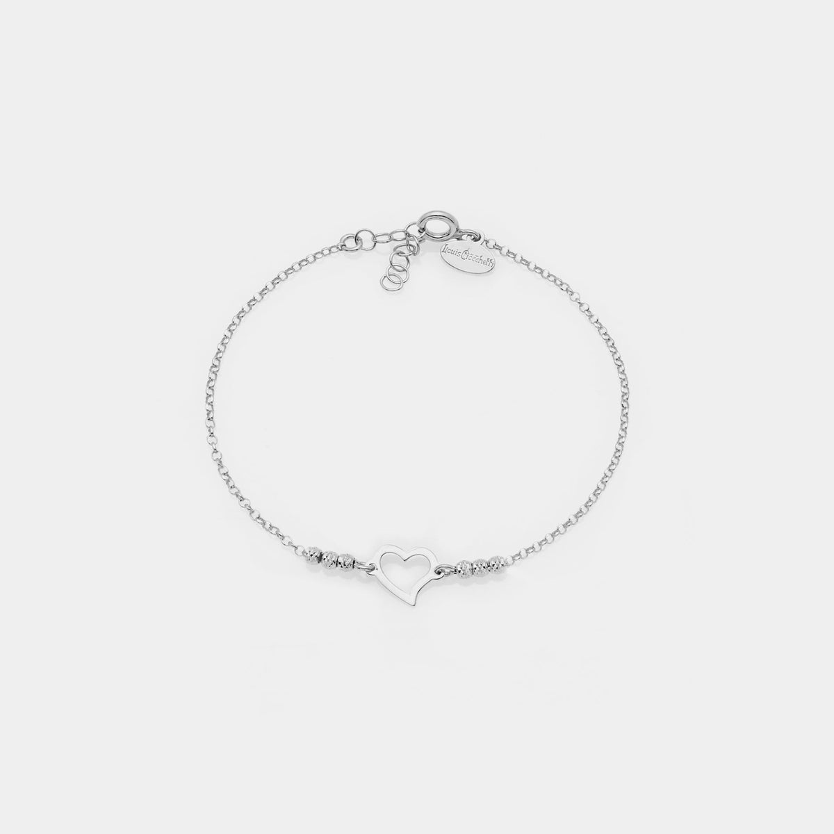 Rhodium-plated silver bracelet with faceted spheres and twisted pierced heart centerpiece