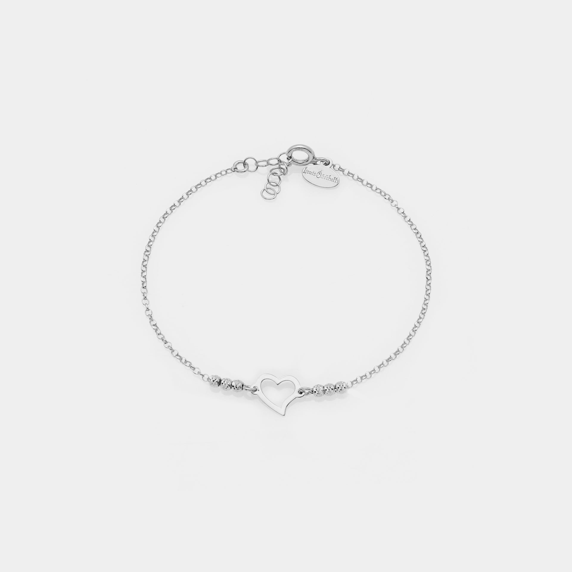 Rhodium-plated silver bracelet with faceted spheres and twisted pierced heart centerpiece