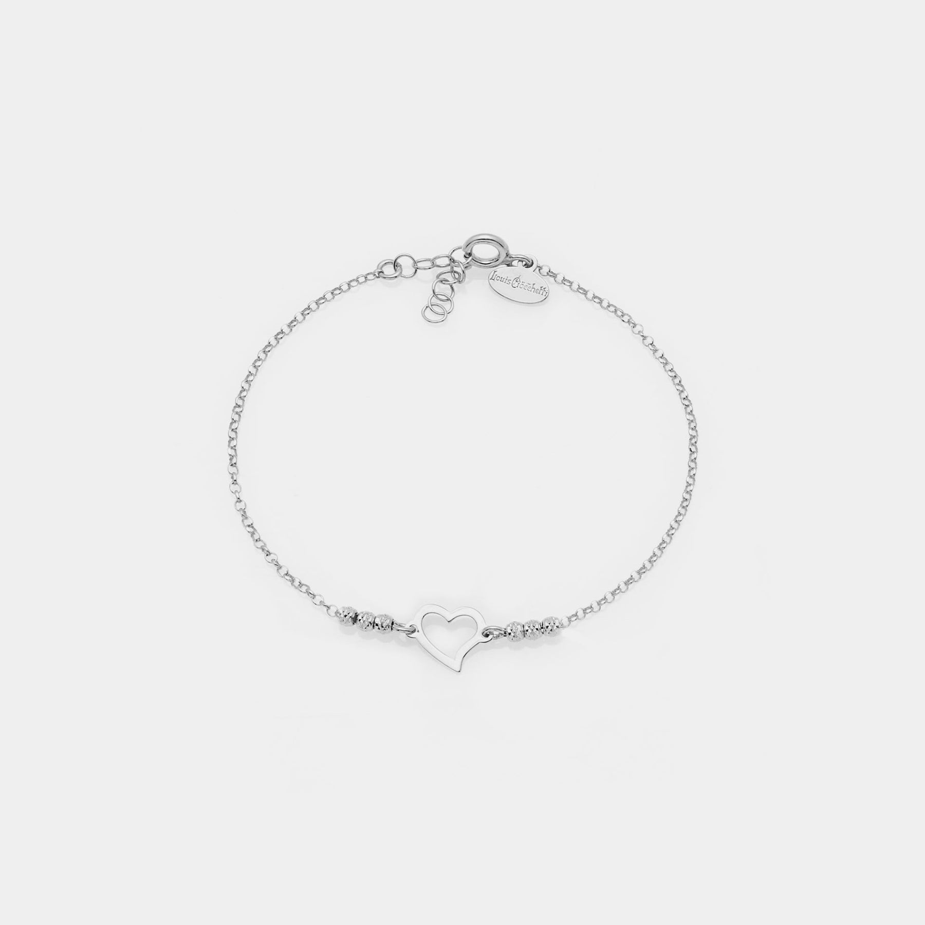Rhodium-plated silver bracelet with faceted spheres and twisted pierced heart centerpiece