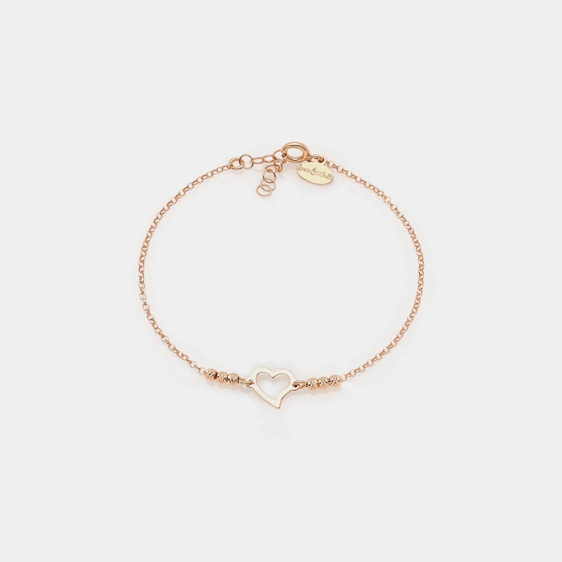 Rose gold plated silver bracelet with faceted spheres and central pierced twisted heart