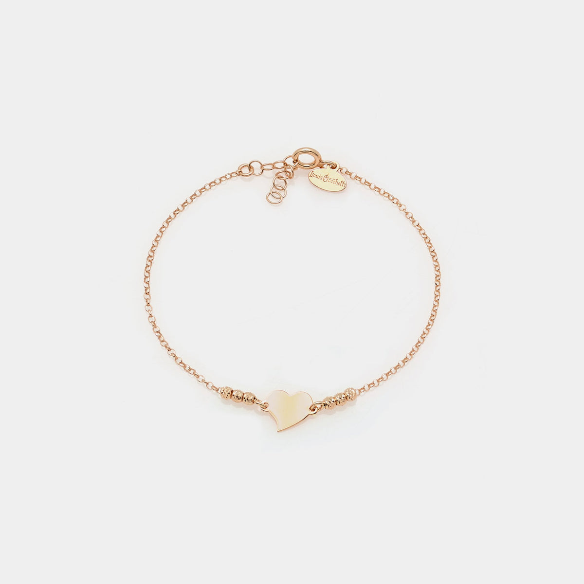 Rose gold silver bracelet with faceted spheres and central twisted heart