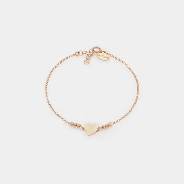 Rose gold silver bracelet with faceted spheres and central twisted heart