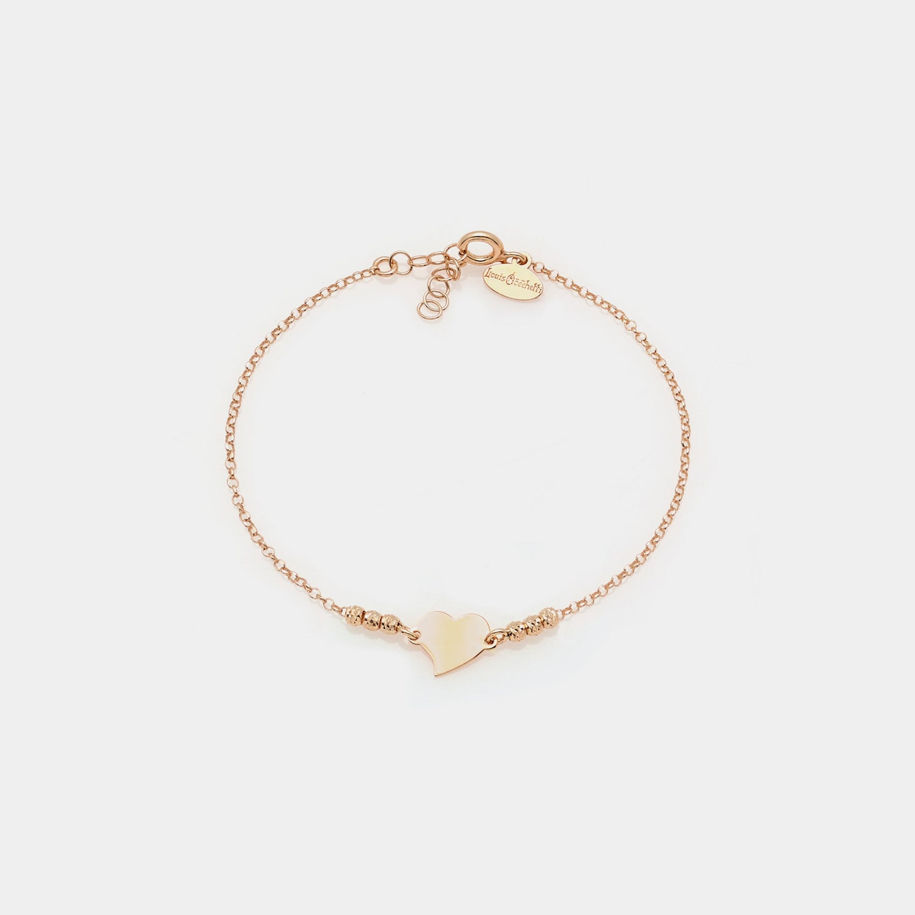 Bracciale argento rosato con sfere sfaccettate e cuore storto centrale