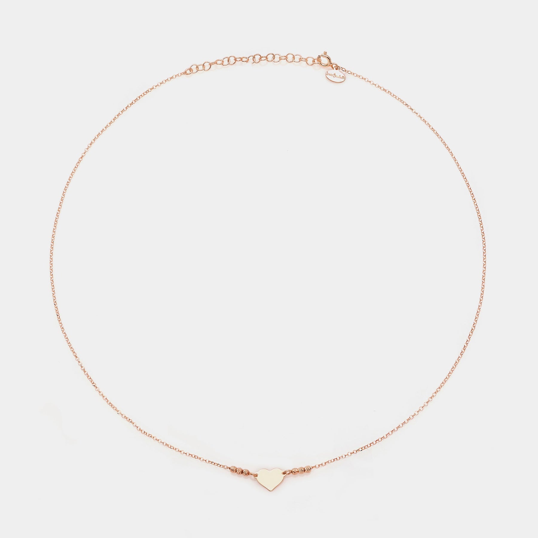 Rose gold silver necklace with simple heart centerpiece and 3 faceted spheres on the sides