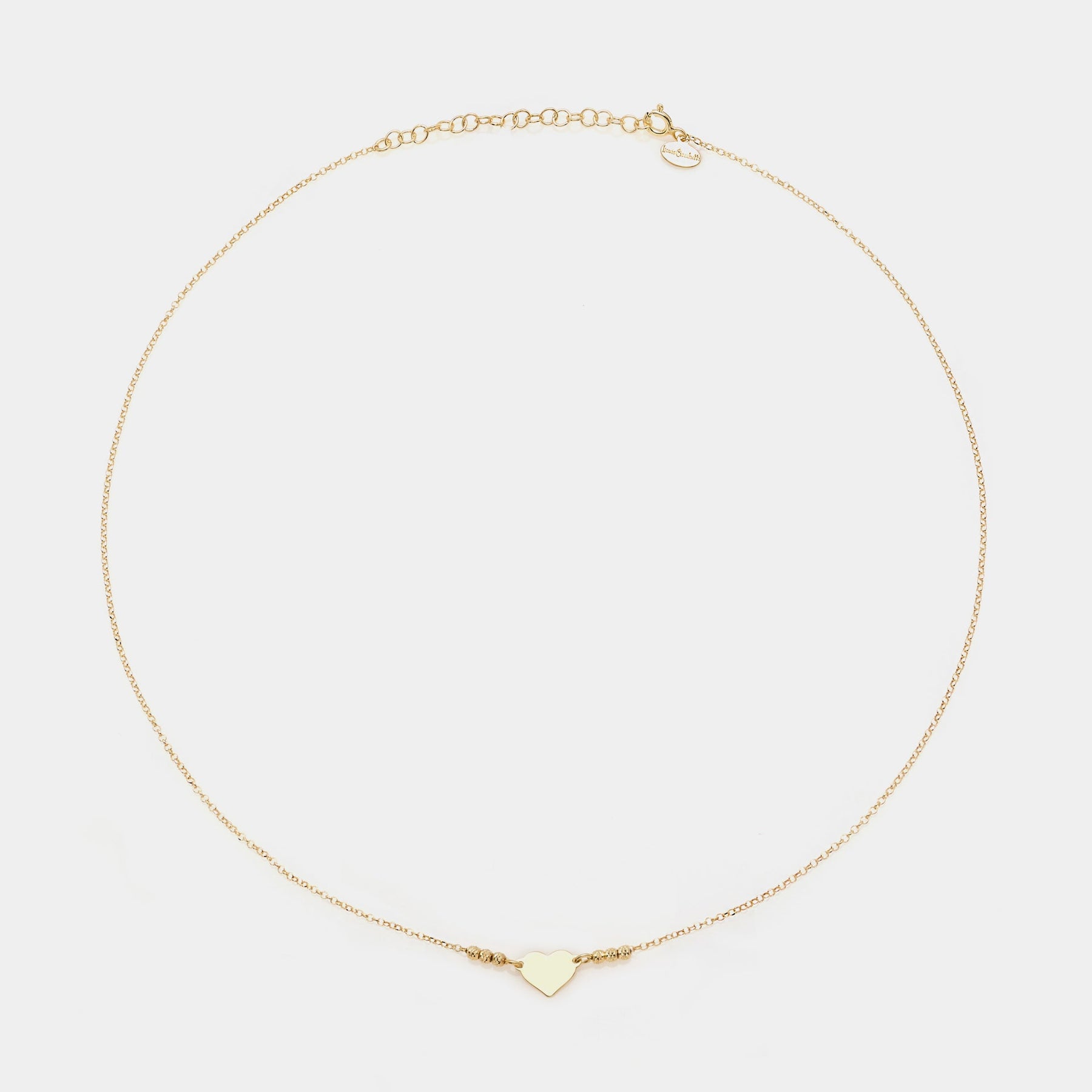 Gold-plated silver necklace with simple heart centerpiece and 3 faceted spheres on the sides