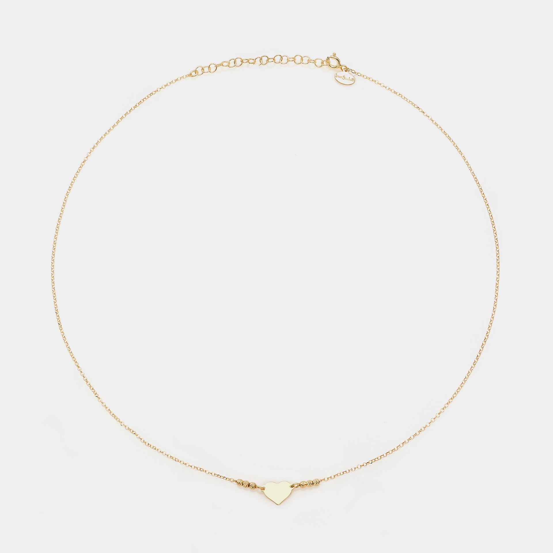 Gold-plated silver necklace with simple heart centerpiece and 3 faceted spheres on the sides