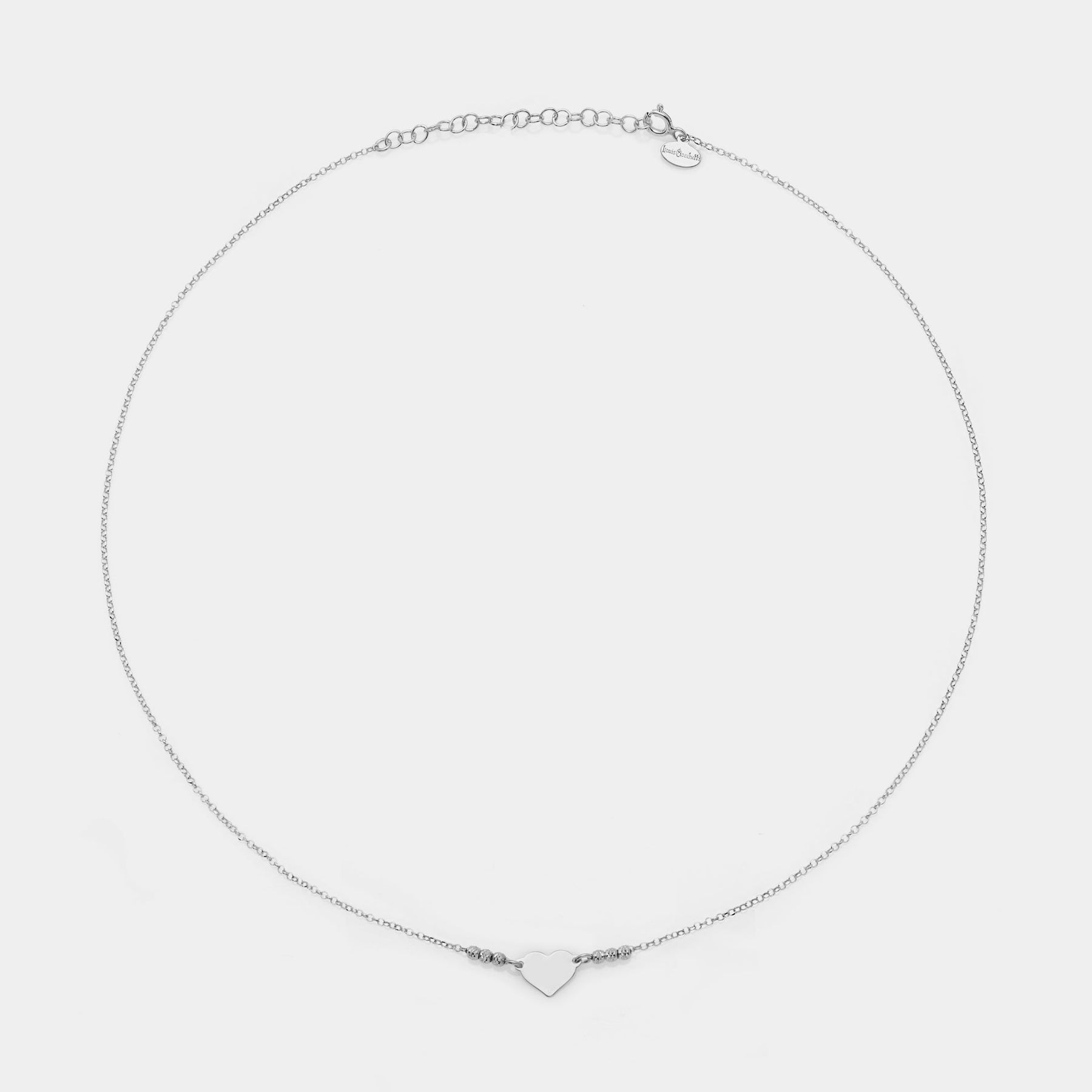 Rhodium-plated silver necklace with simple heart centerpiece and 3 faceted spheres on the sides