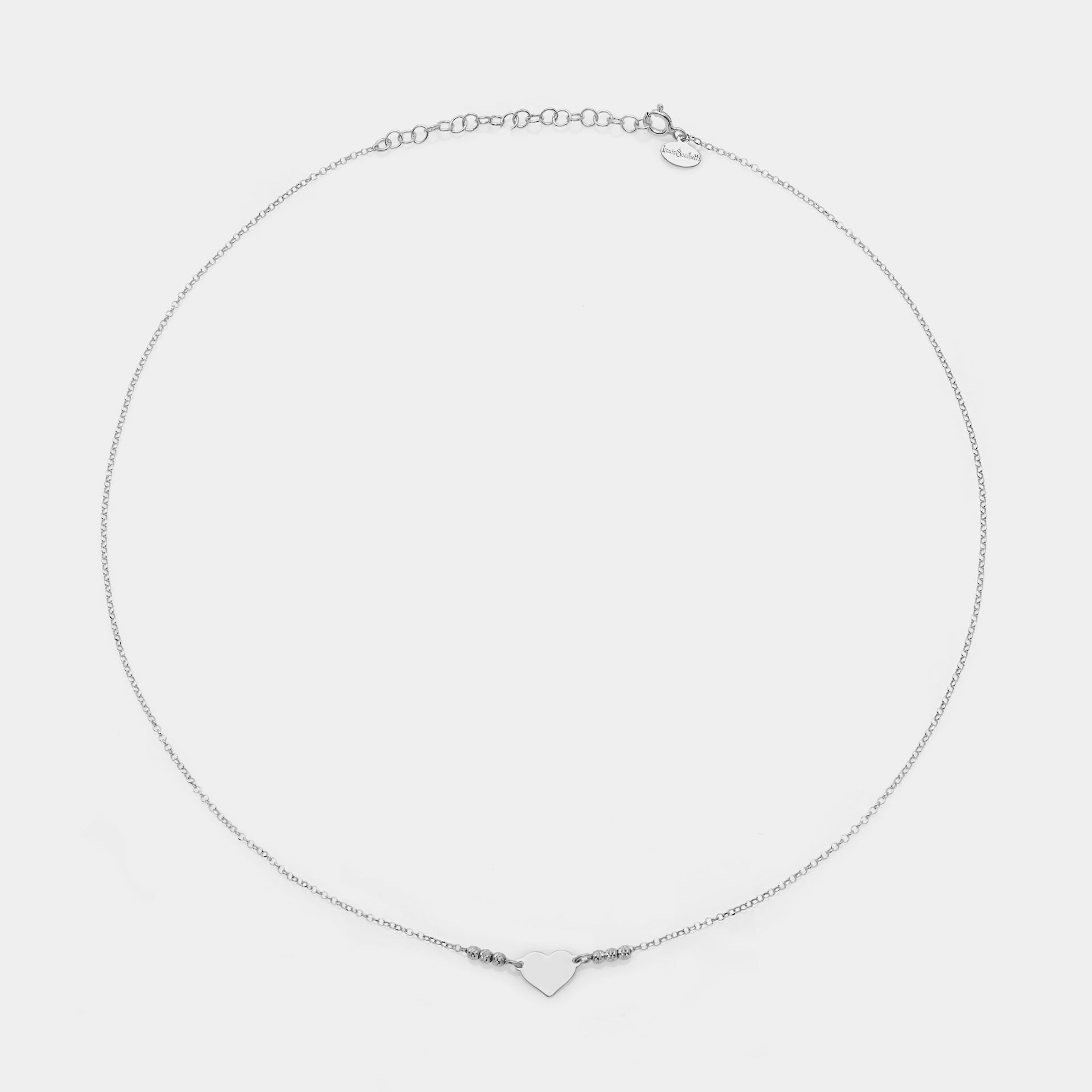 Rhodium-plated silver necklace with simple heart centerpiece and 3 faceted spheres on the sides