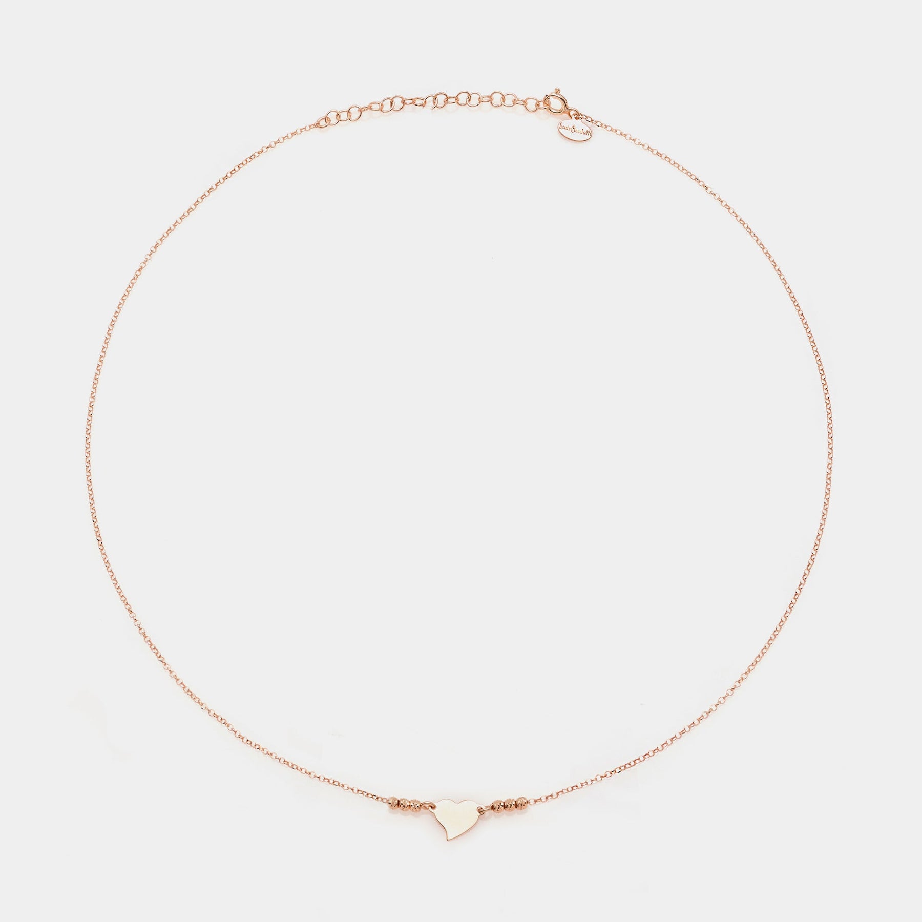 Rose gold silver necklace with twisted heart centerpiece and 3 faceted spheres on the sides