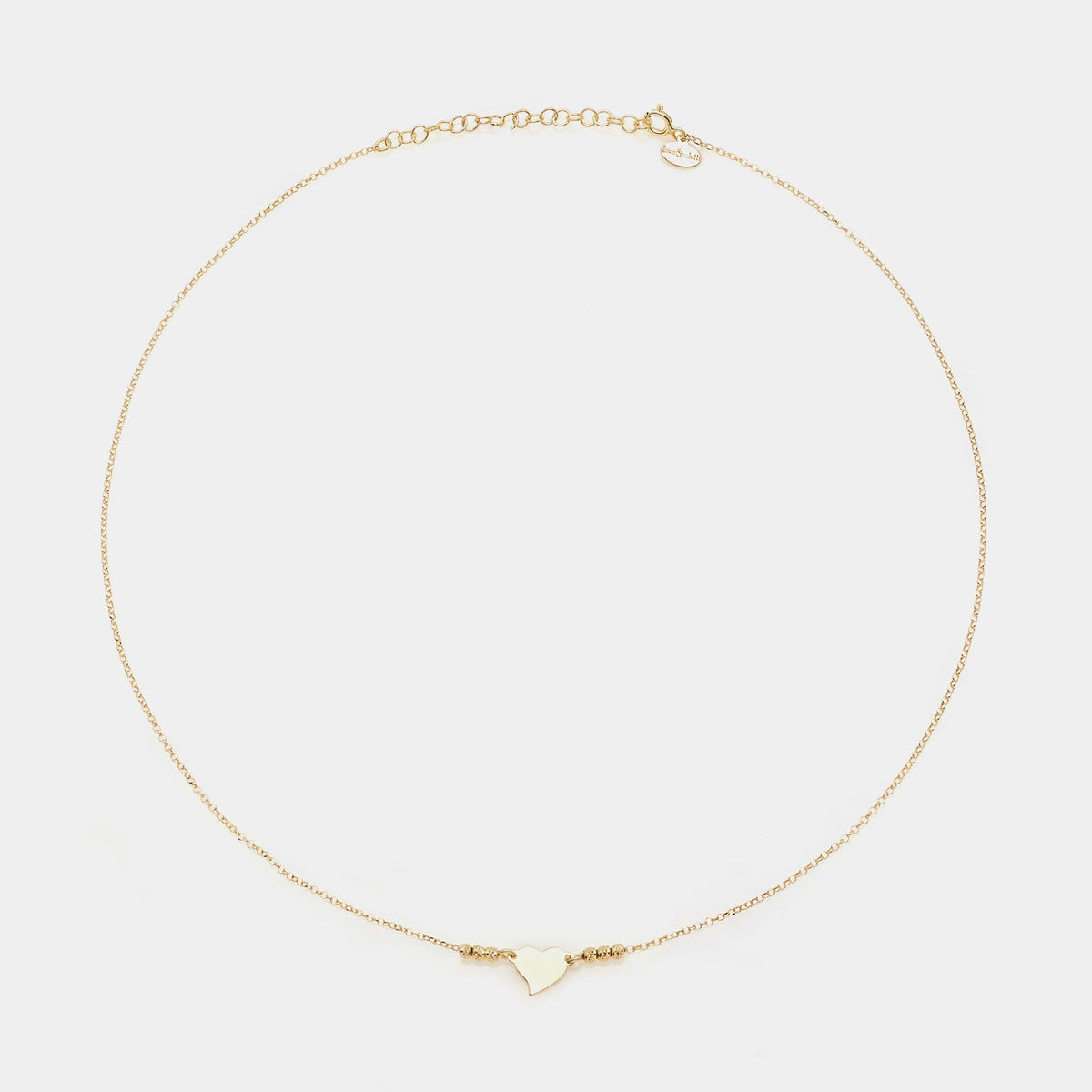 Gold-plated silver necklace with twisted heart centerpiece and 3 faceted spheres on the sides