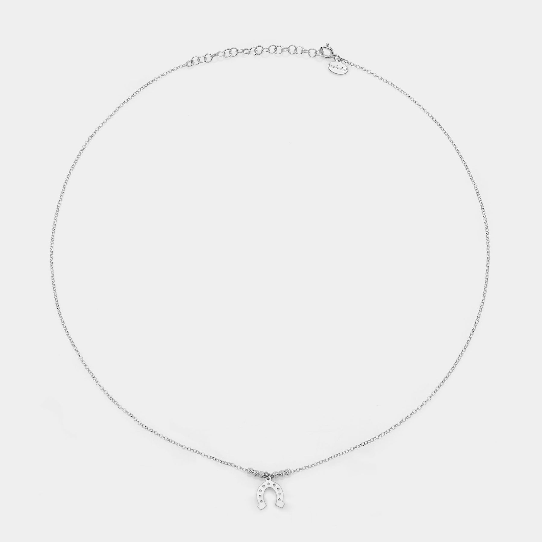 Rhodium-plated silver necklace with central horseshoe pendant and 3 faceted spheres on the sides