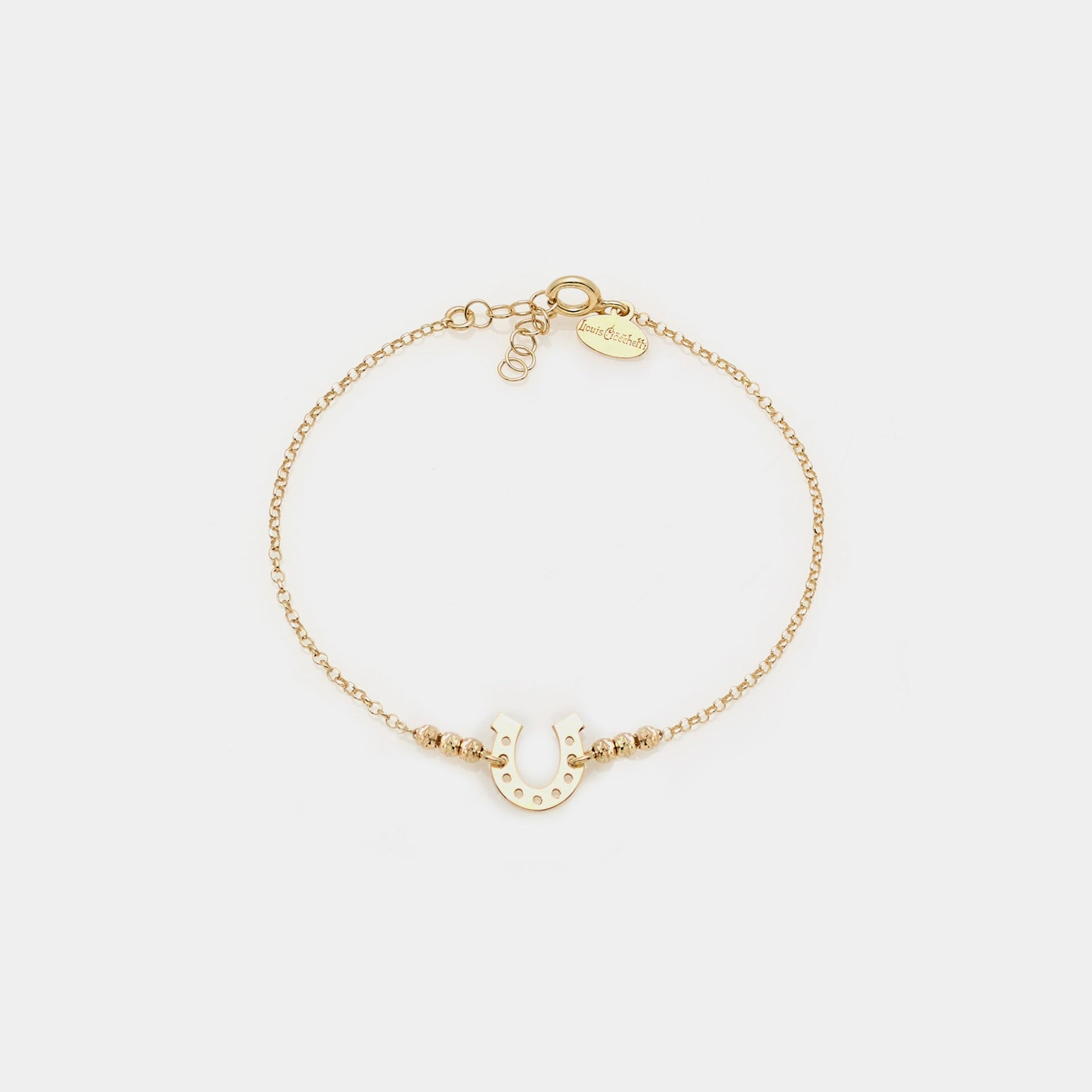 Gold-plated silver bracelet with faceted spheres and central horseshoe