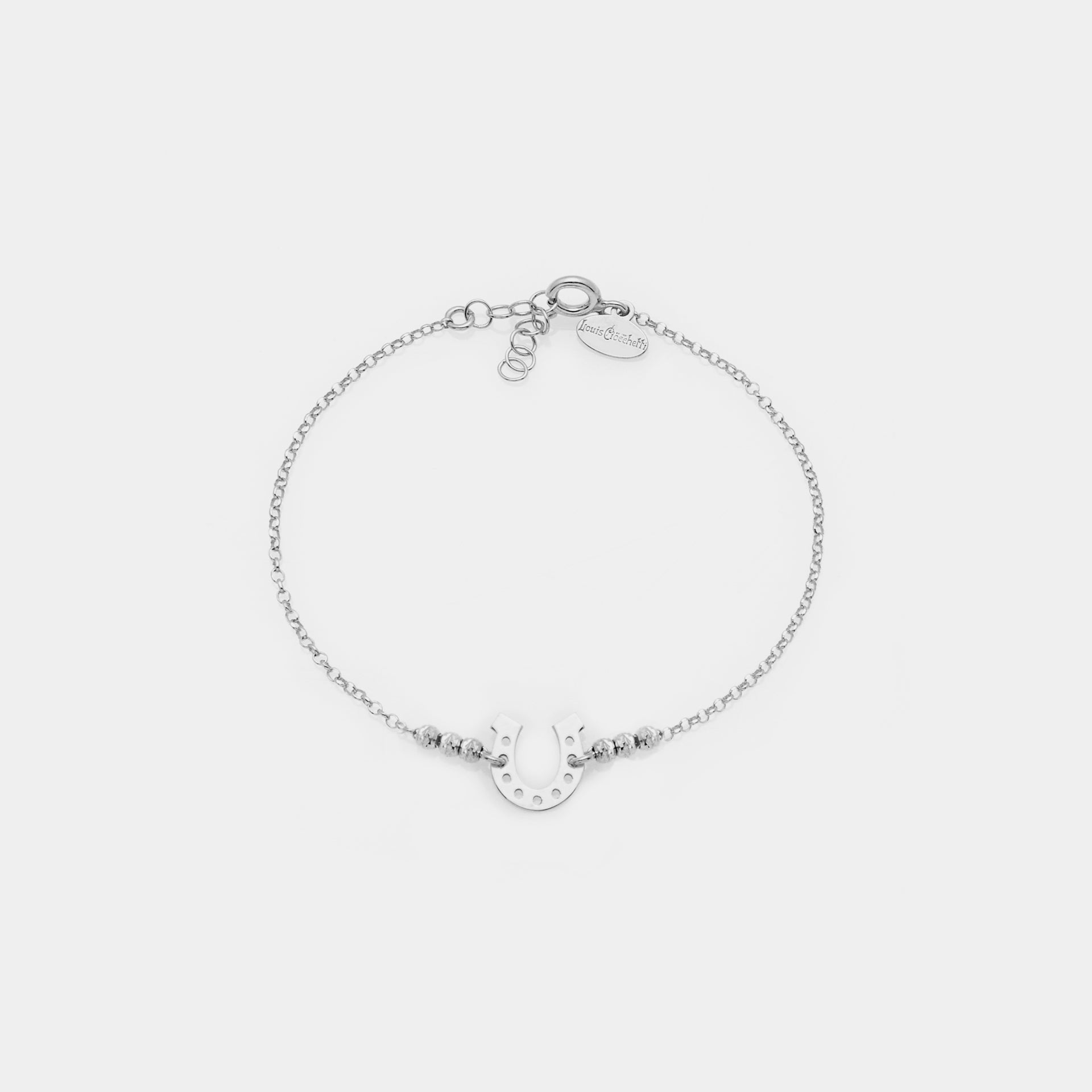 Rhodium-plated silver bracelet with faceted spheres and central horseshoe