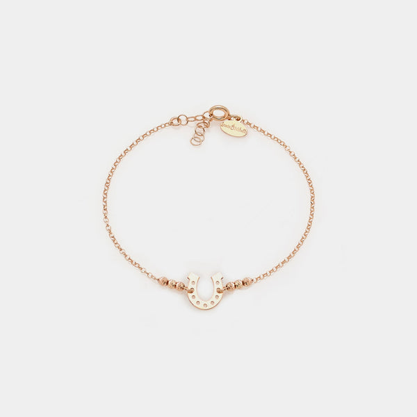 Rose gold plated silver bracelet with faceted spheres and central horseshoe