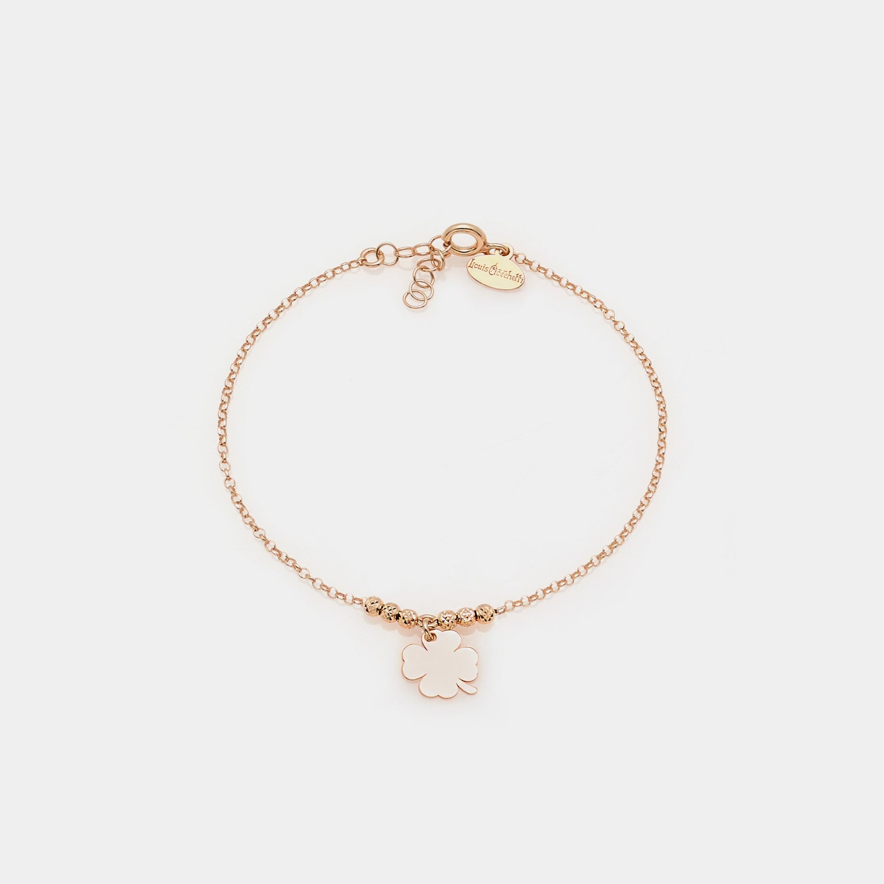 Rose gold silver bracelet with faceted spheres and central hanging four-leaf clover