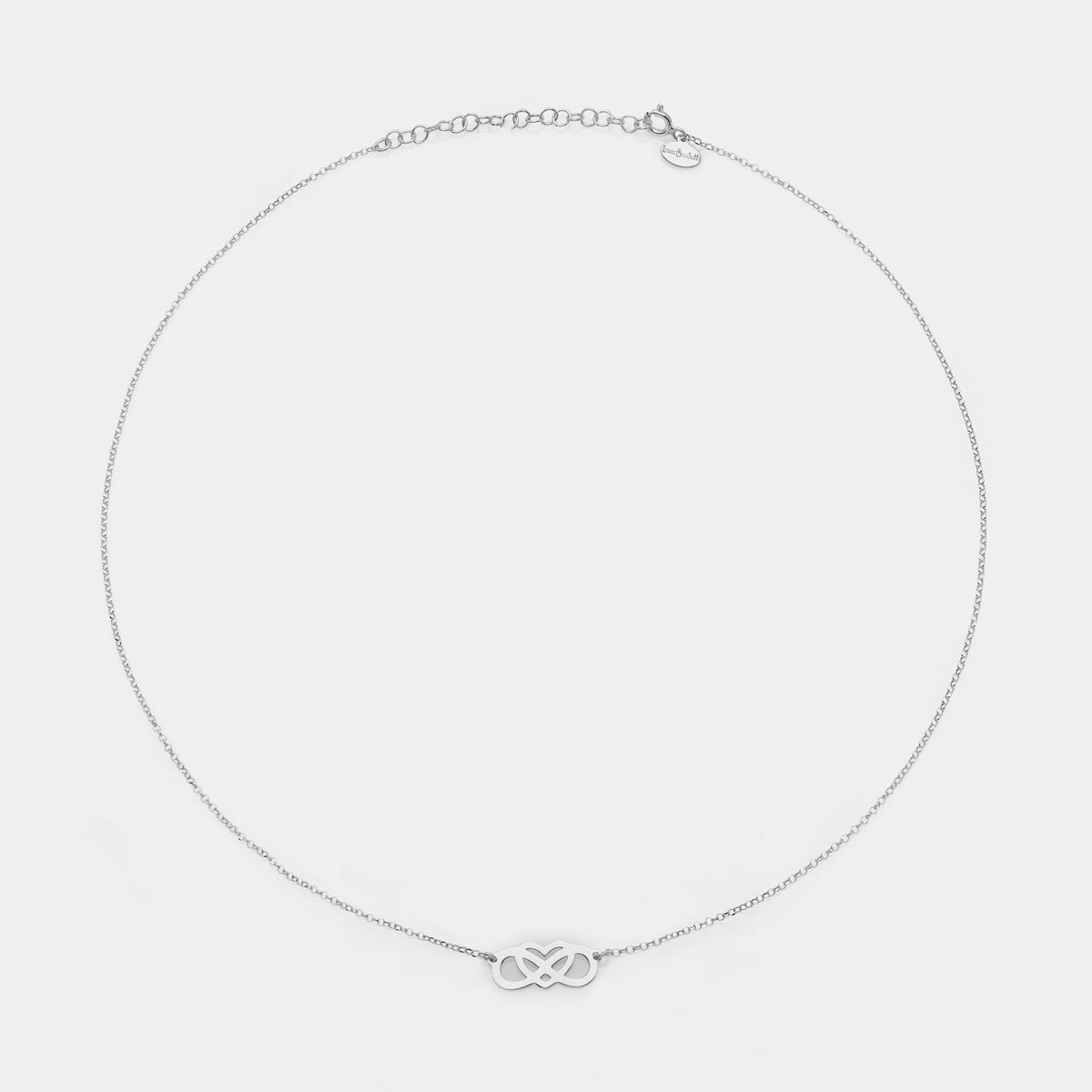 Rhodium-plated silver necklace with intertwined and perforated infinity center and heart