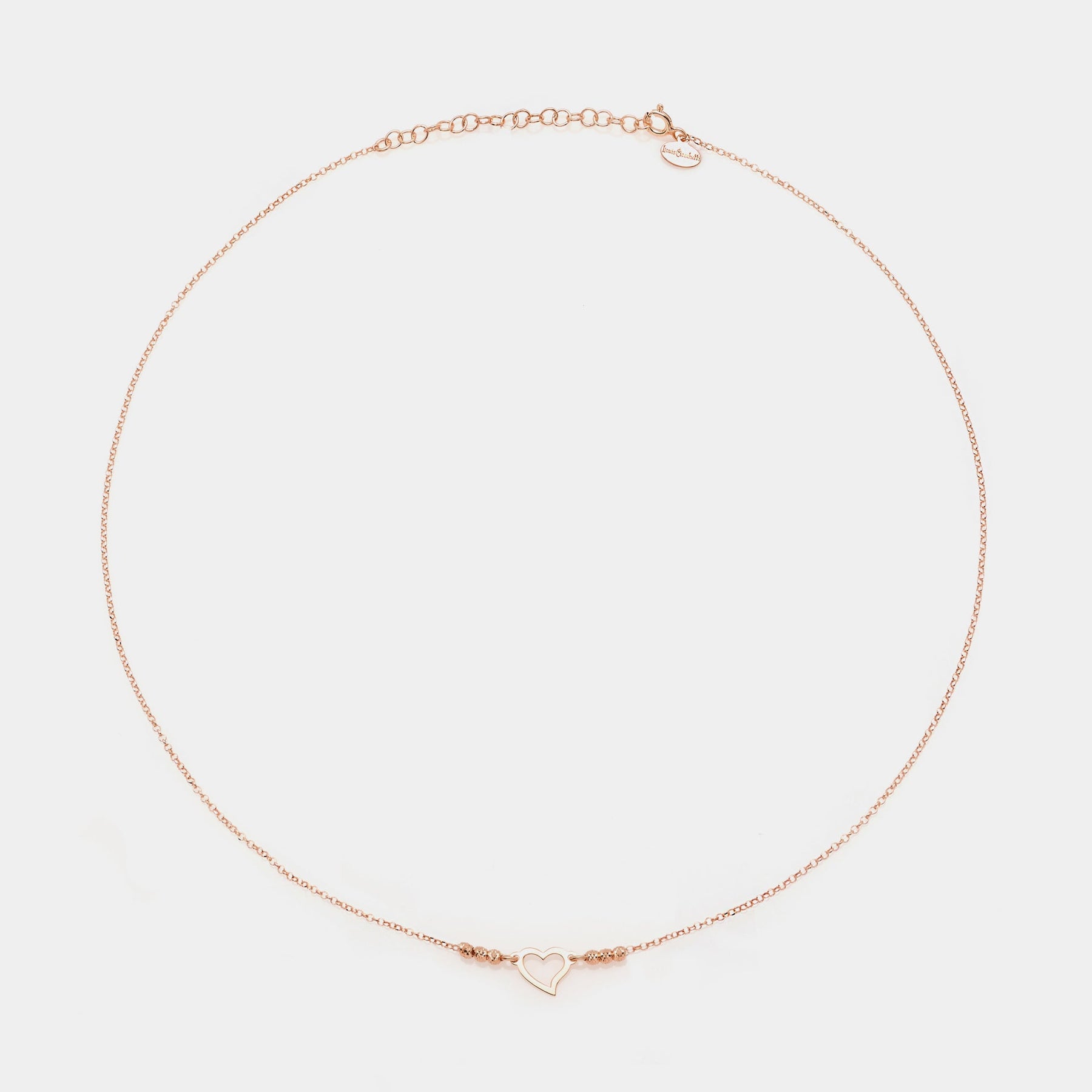Rose gold silver necklace with twisted heart centerpiece and 3 faceted spheres on the sides