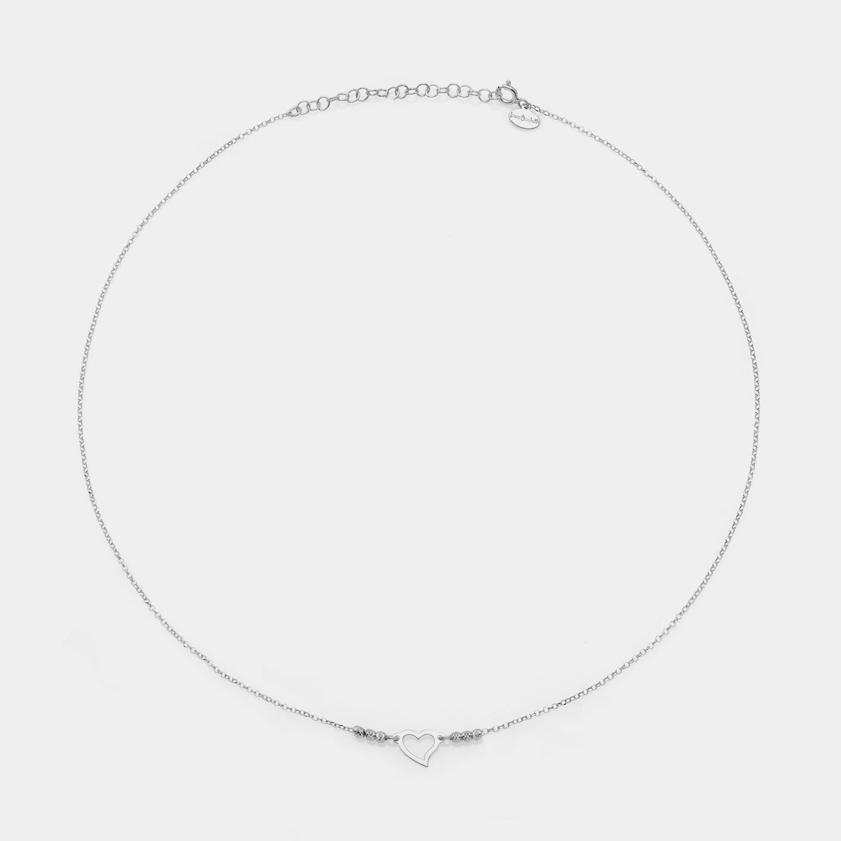 Rhodium-plated silver necklace with twisted heart centerpiece and 3 faceted spheres on the sides