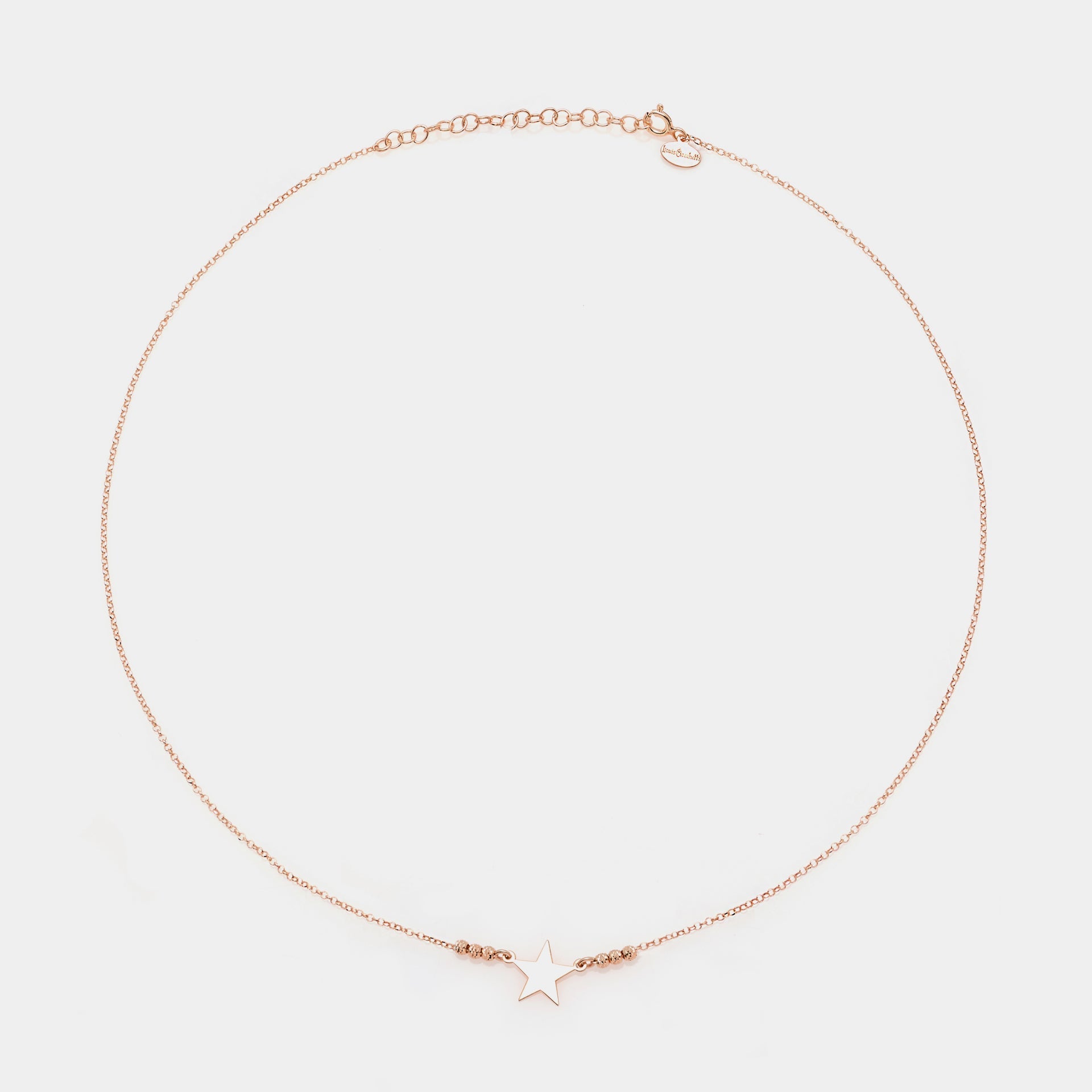 Rose gold silver necklace with star centerpiece and 3 faceted spheres on the sides