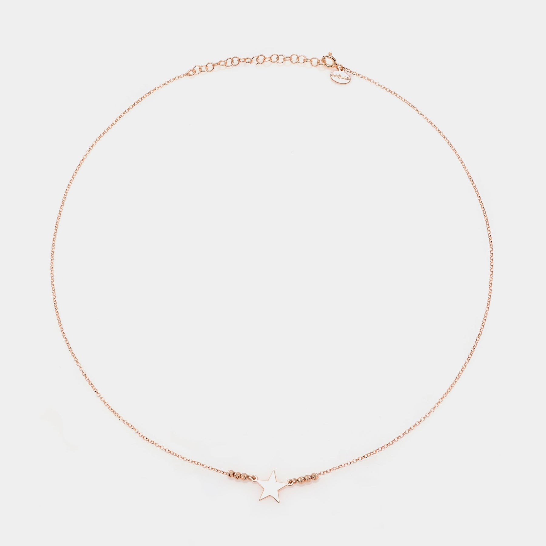Rose gold silver necklace with star centerpiece and 3 faceted spheres on the sides