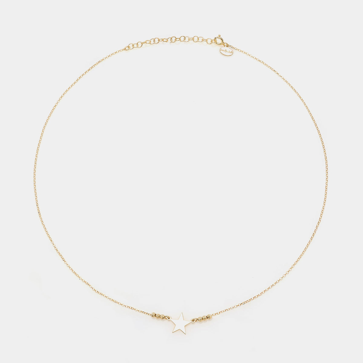 Gold-plated silver necklace with star centerpiece and faceted spheres on the sides