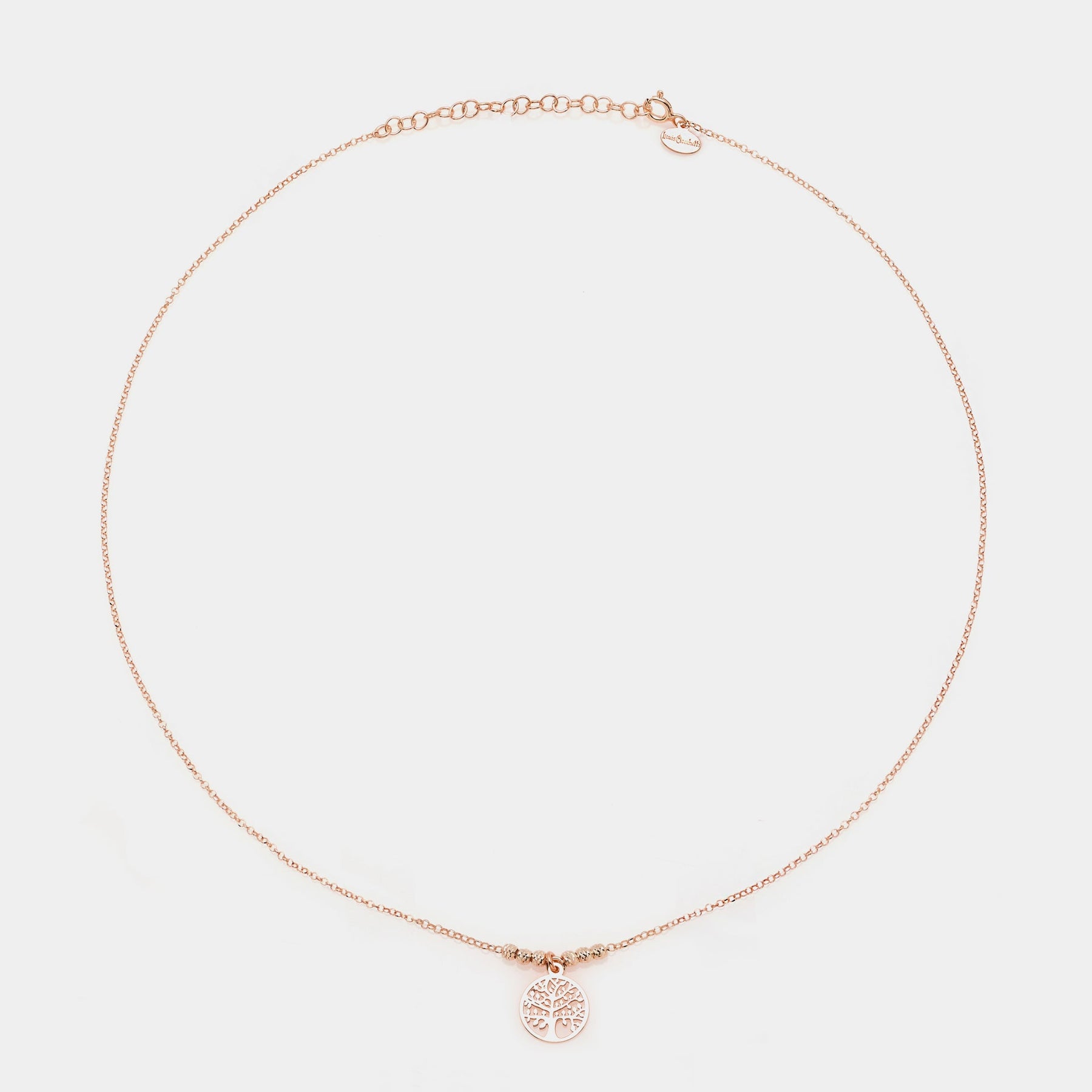 Rose gold silver necklace with round pierced tree of life pendant and faceted spheres on the sides