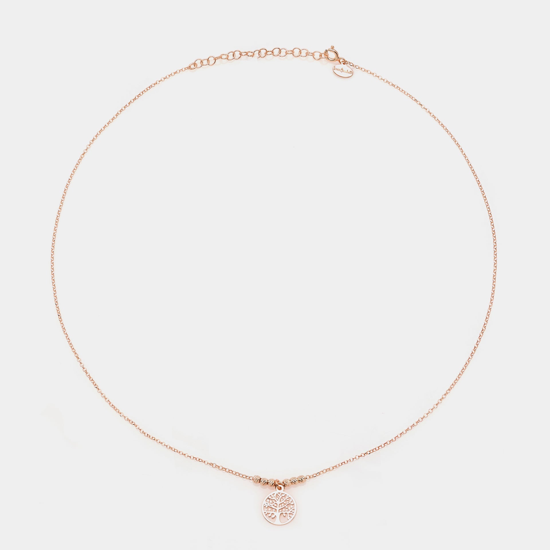 Rose gold silver necklace with round pierced tree of life pendant and faceted spheres on the sides
