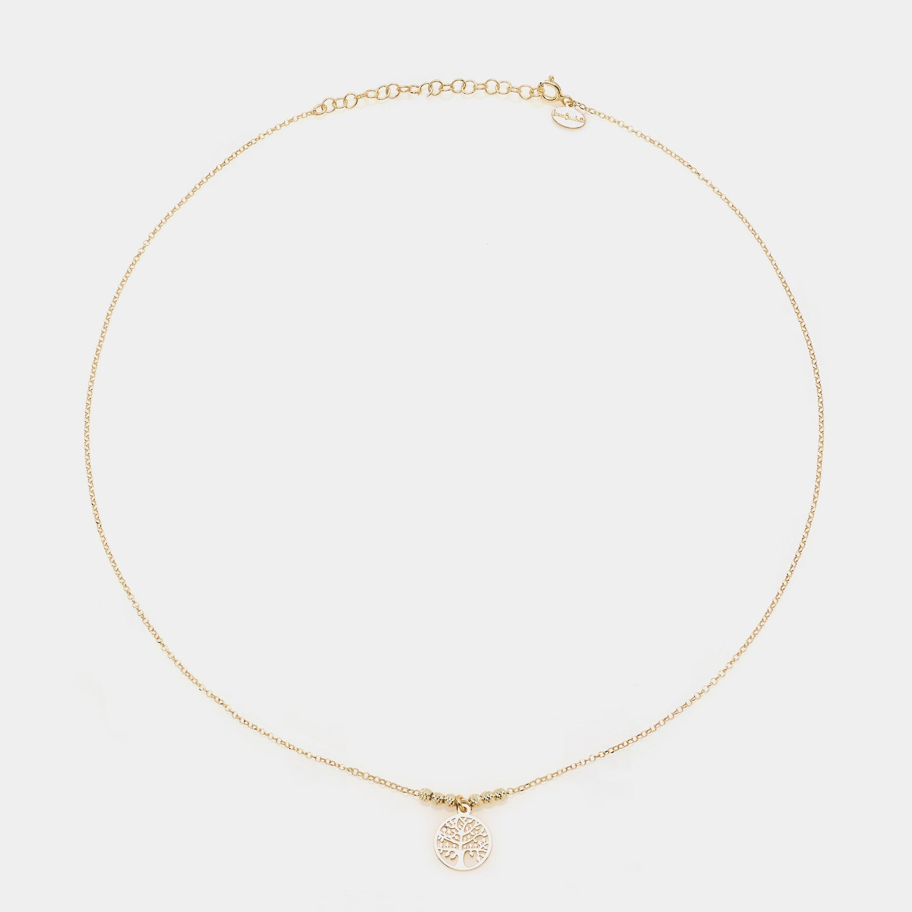Gold-plated silver necklace with round pierced tree of life pendant and faceted spheres on the sides