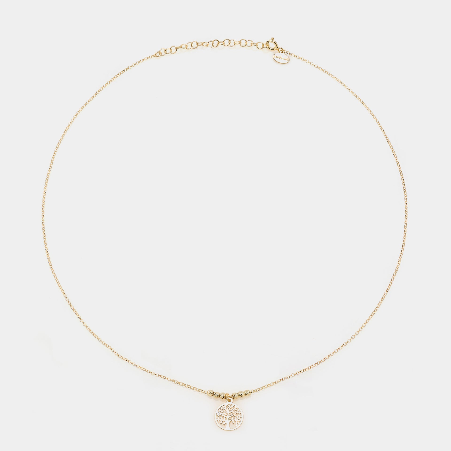 Gold-plated silver necklace with round pierced tree of life pendant and faceted spheres on the sides