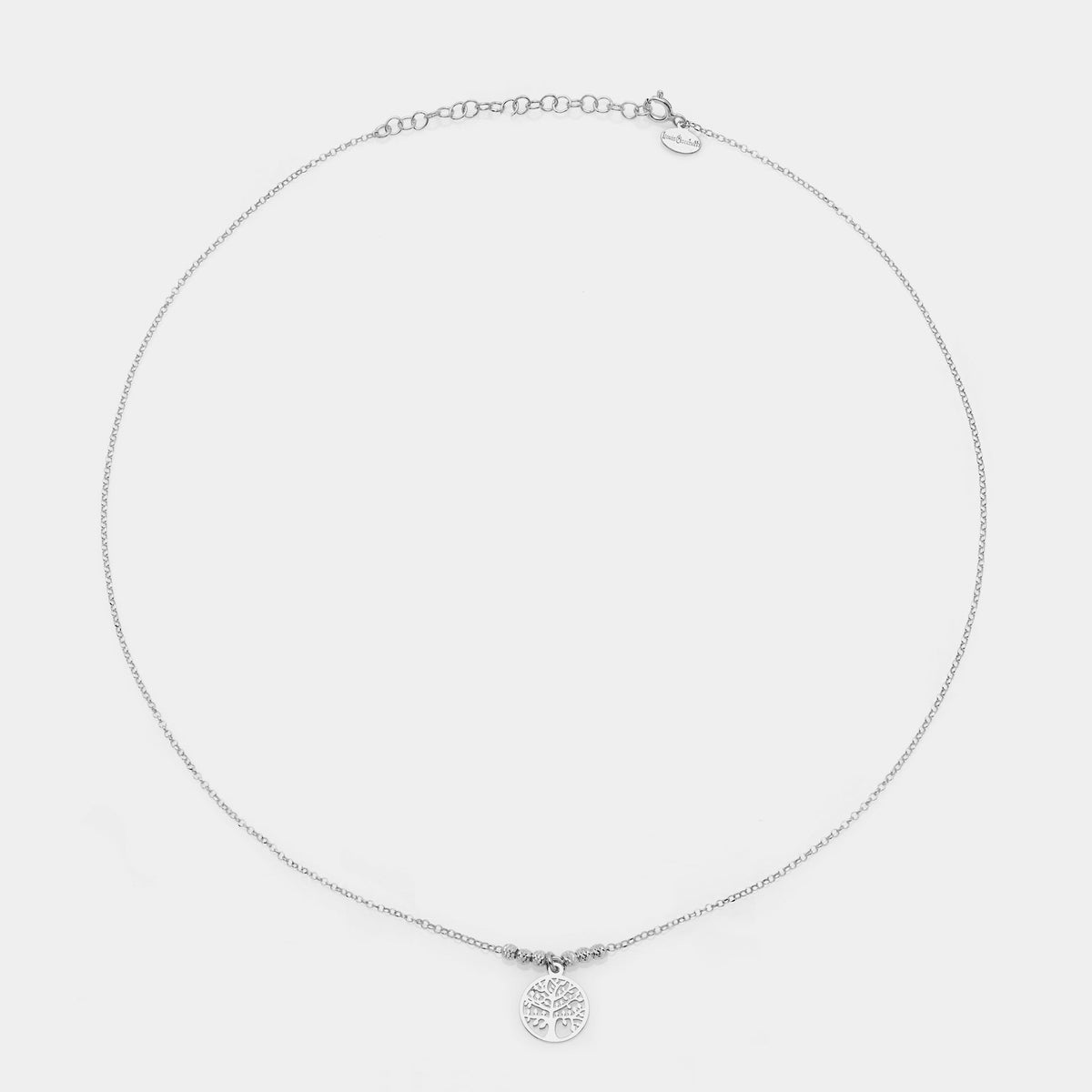 Rhodium-plated silver necklace with central round pierced tree of life pendant and 3 faceted spheres on the sides