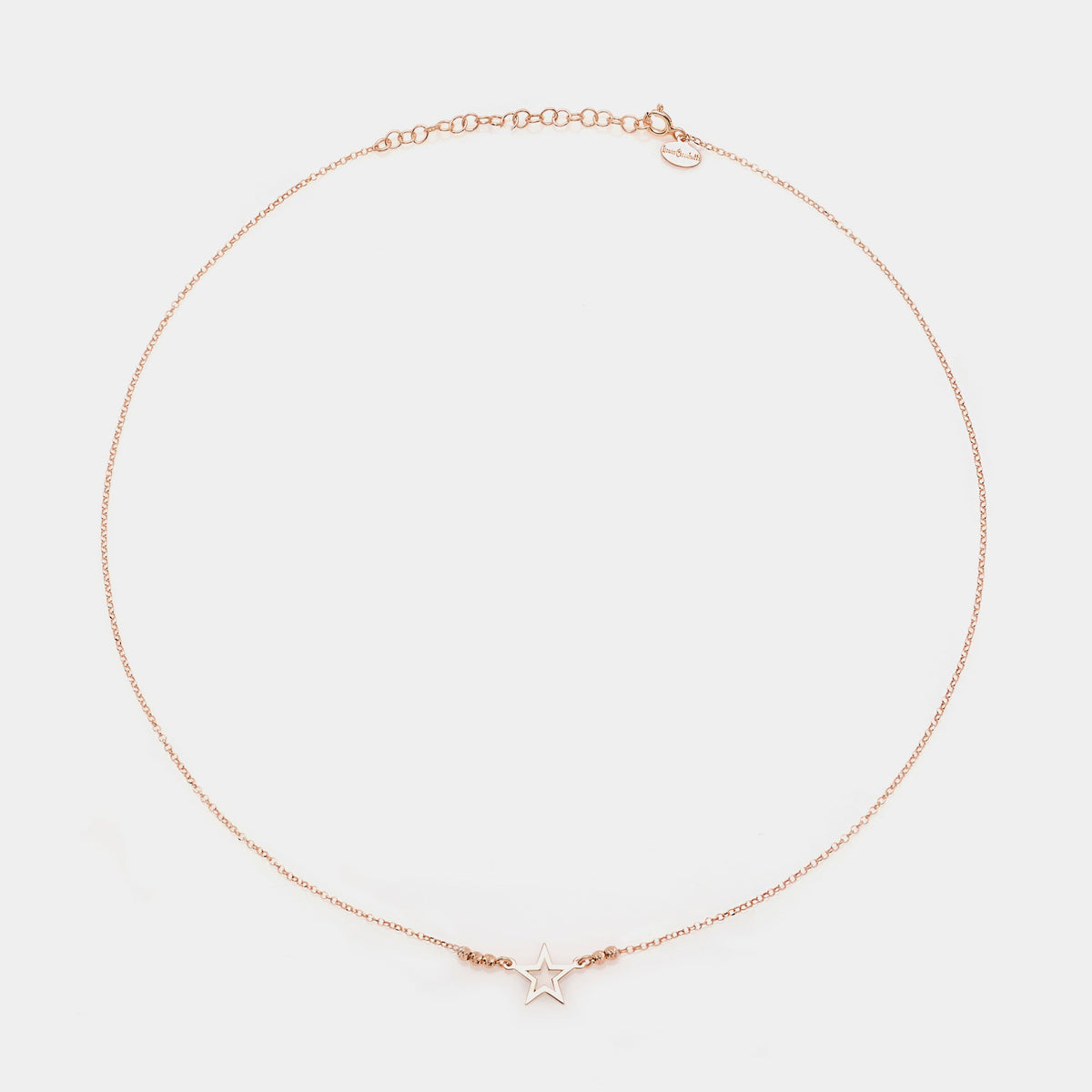 Rose gold silver necklace with pierced star centerpiece and 3 faceted spheres on the sides