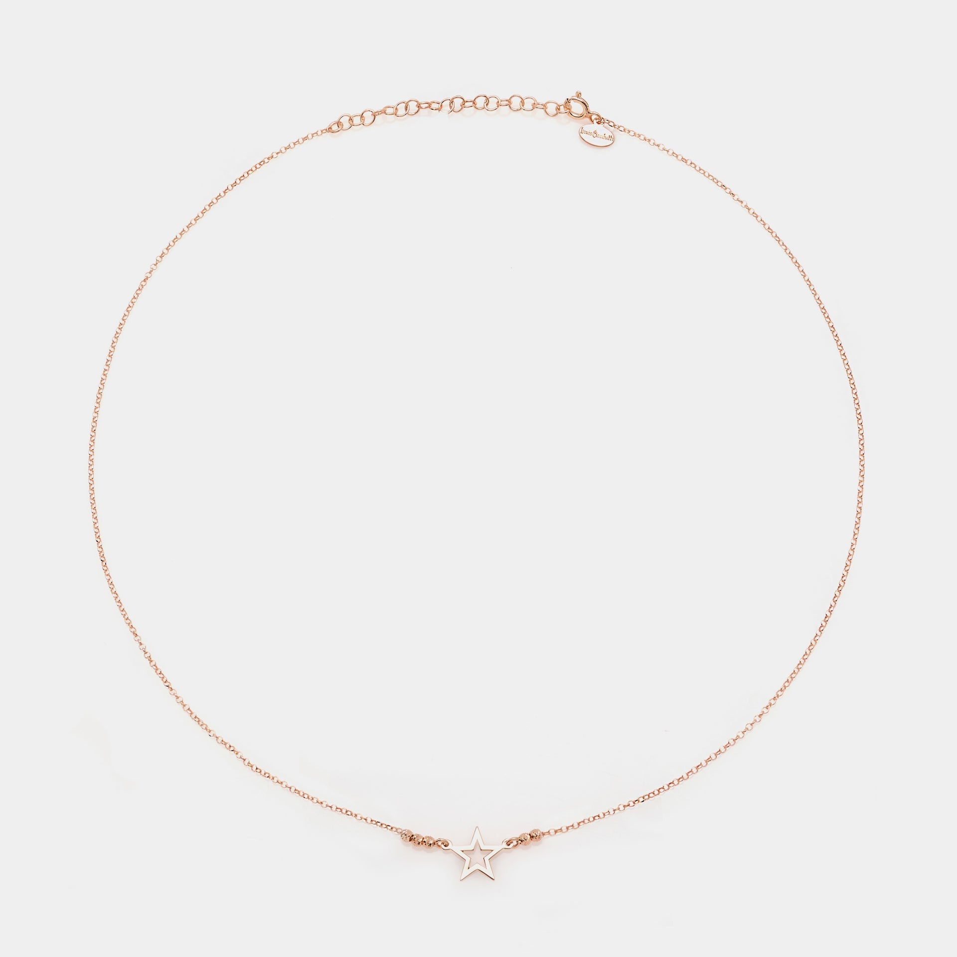 Rose gold silver necklace with pierced star centerpiece and 3 faceted spheres on the sides