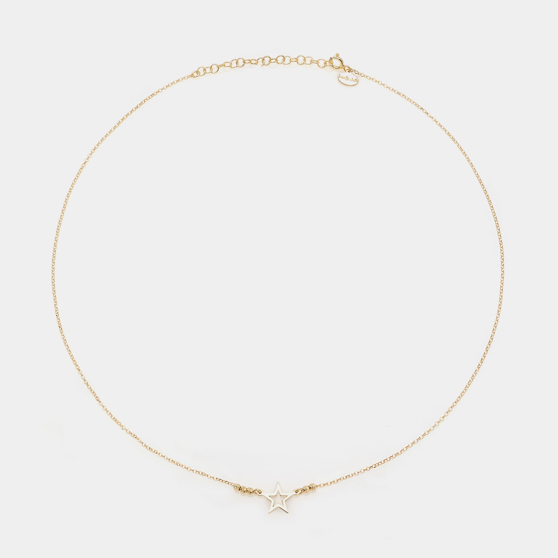 Gold-plated silver necklace with pierced star centerpiece and faceted spheres on the sides