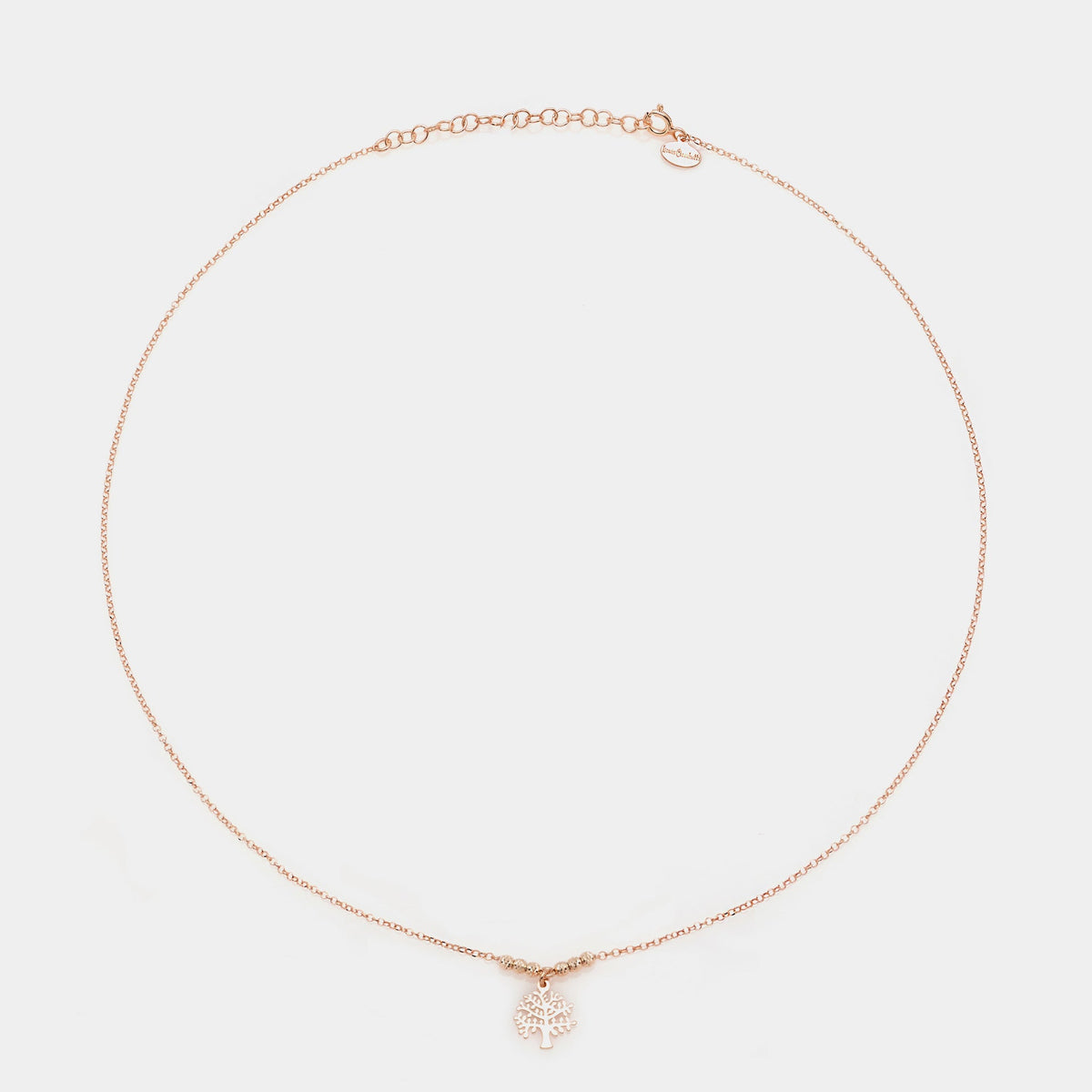 Rose gold silver necklace with pierced tree of life pendant and faceted spheres on the sides