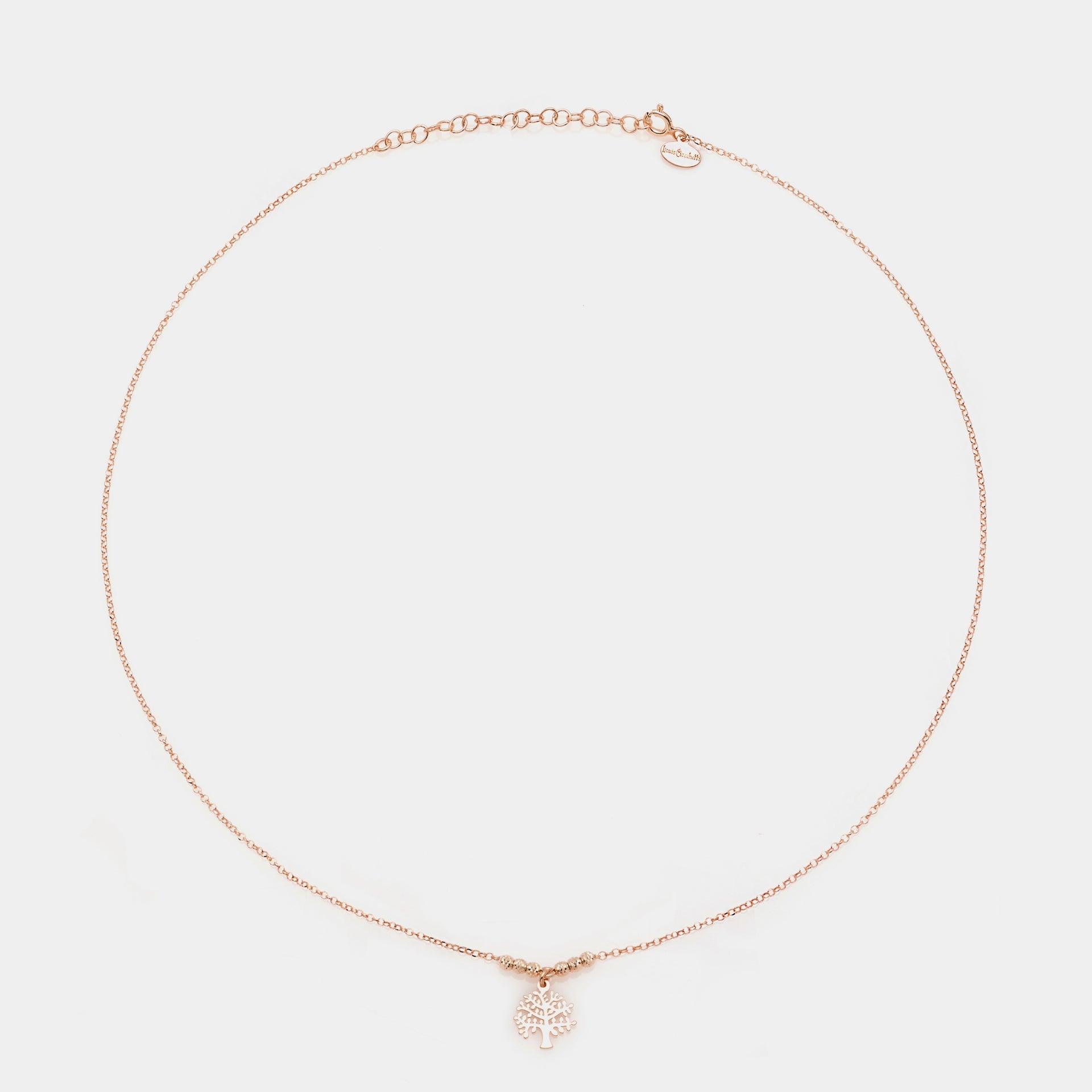 Rose gold silver necklace with pierced tree of life pendant and faceted spheres on the sides