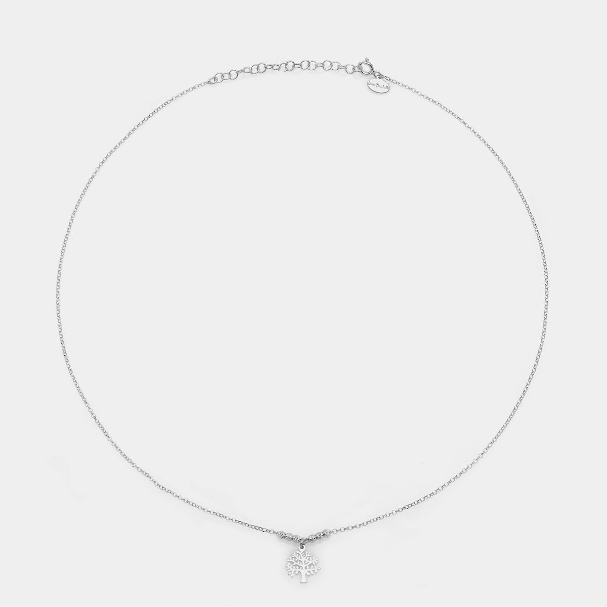Rhodium-plated silver necklace with pierced tree of life pendant and faceted spheres on the sides