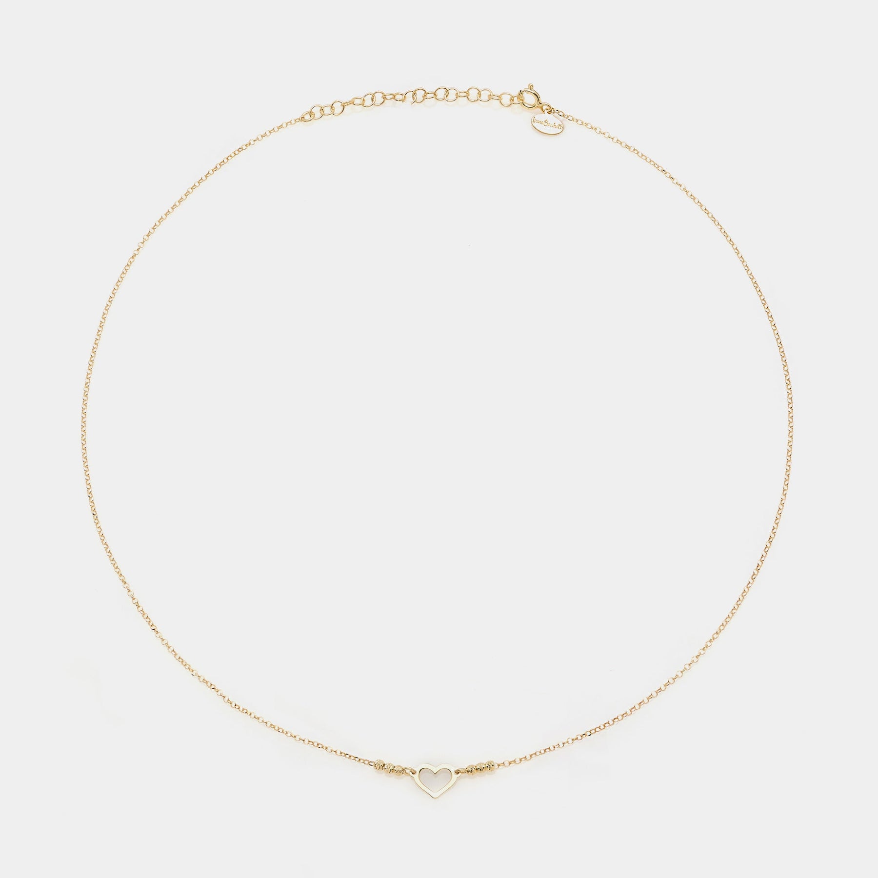 Gold-plated silver necklace with simple pierced heart centerpiece and faceted spheres on the sides