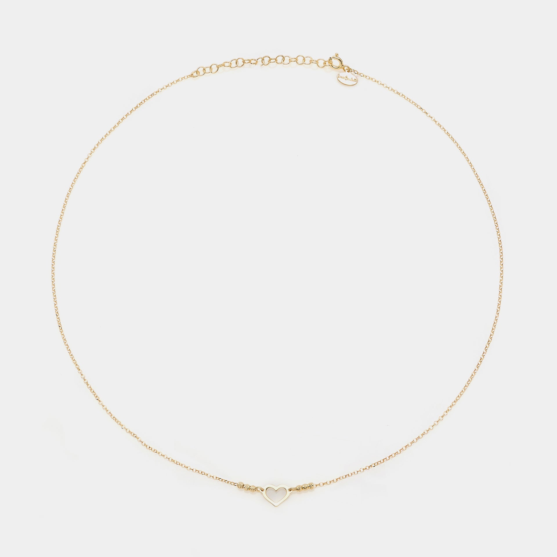 Gold-plated silver necklace with simple pierced heart centerpiece and faceted spheres on the sides