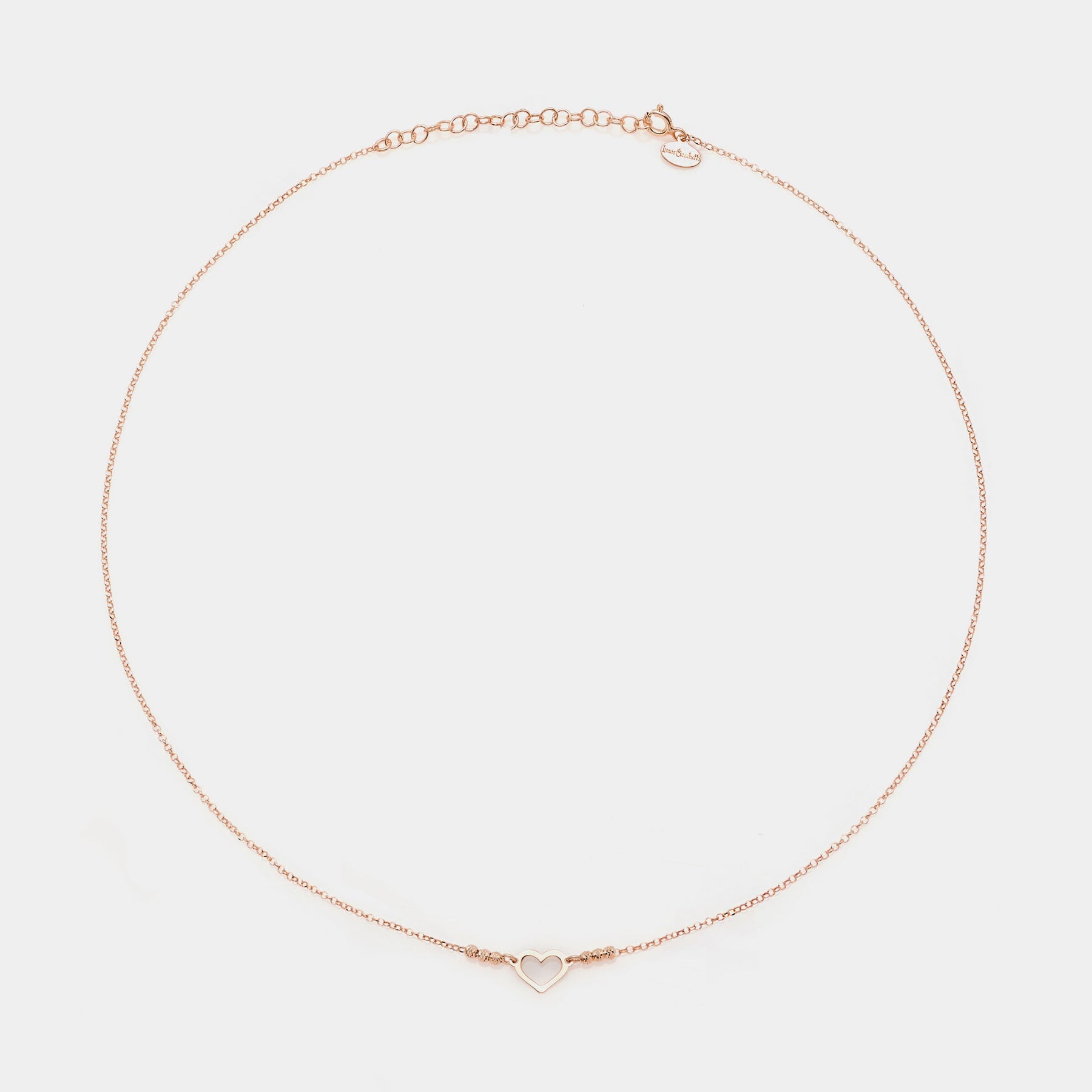 Rose gold silver necklace with simple pierced heart centerpiece and 3 faceted spheres on the sides